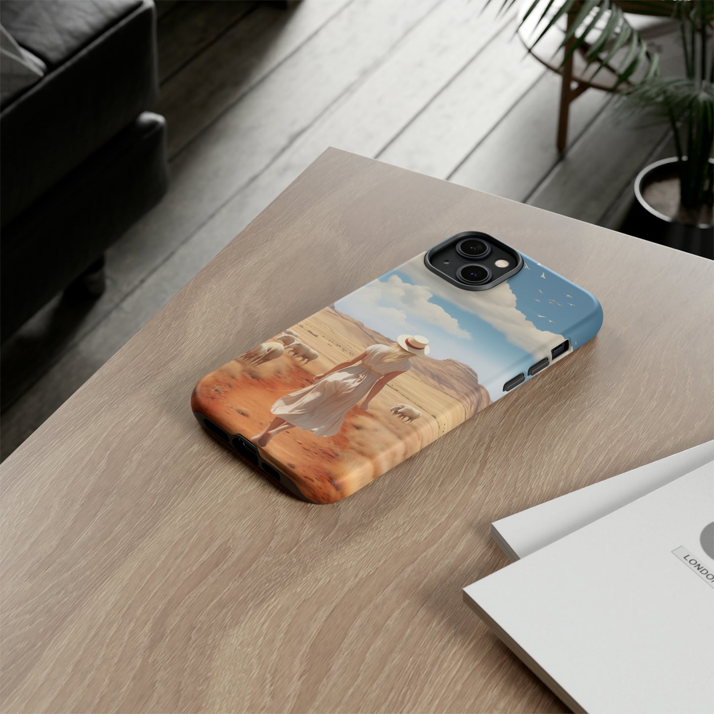 Serenity in Hand: Our Tough Western Cell Phone Case invites you to experience tranquility. A vintage painted design portrays a woman in a skirt and hat walking on a dirt road through a prairie, with grazing sheep. Let the vanishing horizon captivate your senses. Elevate your phone with timeless beauty. #ElizaSinger #PhoneCase