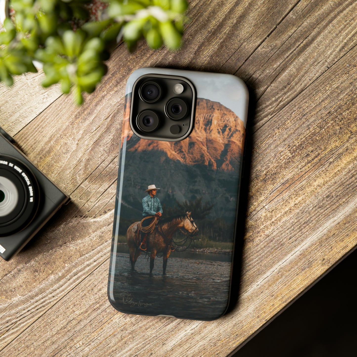 Capture the Wild: Horse Art Western Photo Yellowstone Design iPhone Tough Protective Cover. Featuring a Cowboy amidst Mountains and Buckskin hues, compatible with iPhone 15, 14, 13, XS, XR Pro/Max/Mini/P/Plus. Embrace the Spirit of the West with Style and Durability. #ElizaSinger #PhoneCase #WesternDesign