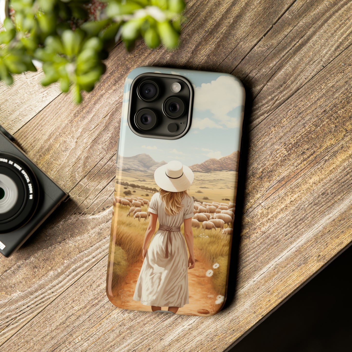 Dreamy Nostalgia: Immerse yourself in a vintage painted landscape with our Tough Western Cell Phone Case. Adorned with a woman in a hat strolling through a prairie with sheep, this edition captures the magic of the past. Elevate your phone with timeless charm. #ElizaSinger #PhoneCase