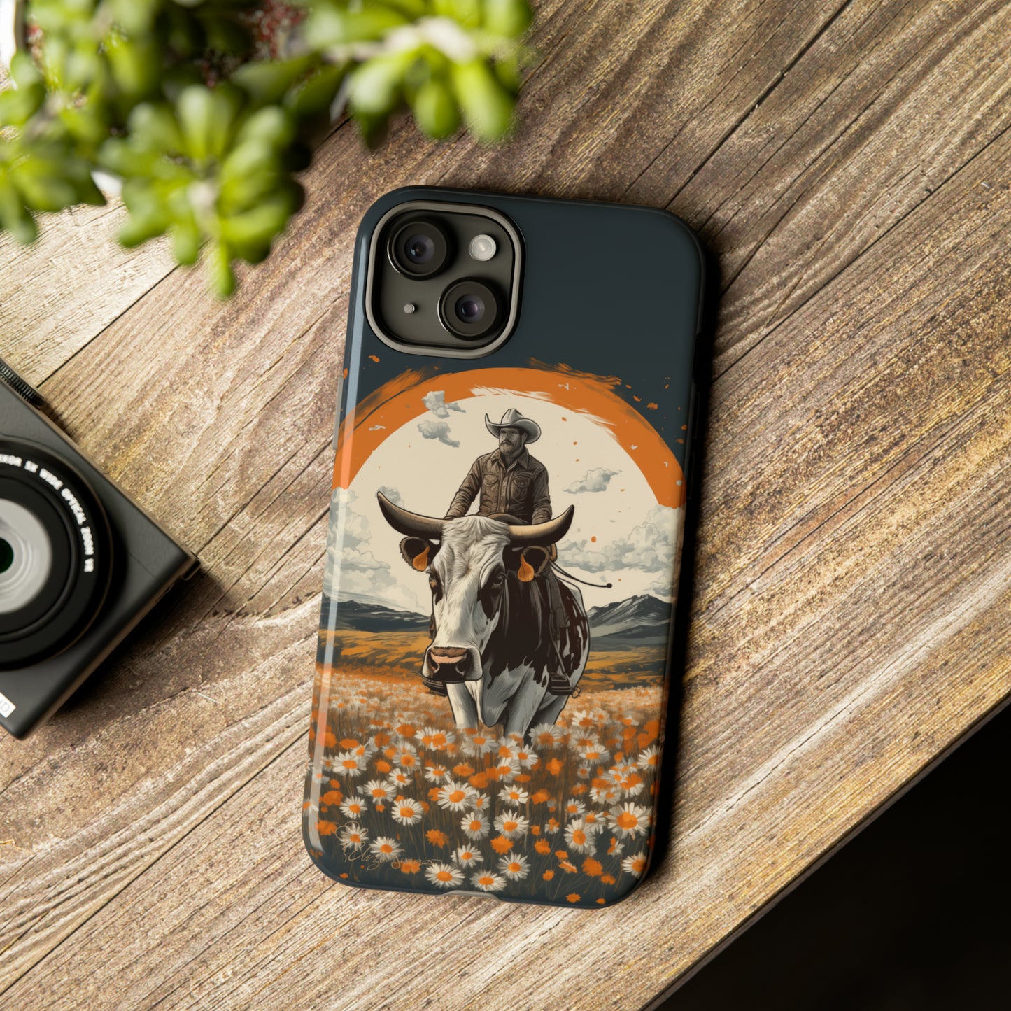 Meet 'Rugged Wrangler': Introducing our Tough Western Cell Phone Case. This unique design seamlessly combines rugged protection with a touch of whimsy, showcasing a fearless cowboy astride a dairy cow amidst a field of vibrant daisies. Elevate your style with this adventurous and protective accessory. #ElizaSinger #PhoneCase #RuggedWrangler