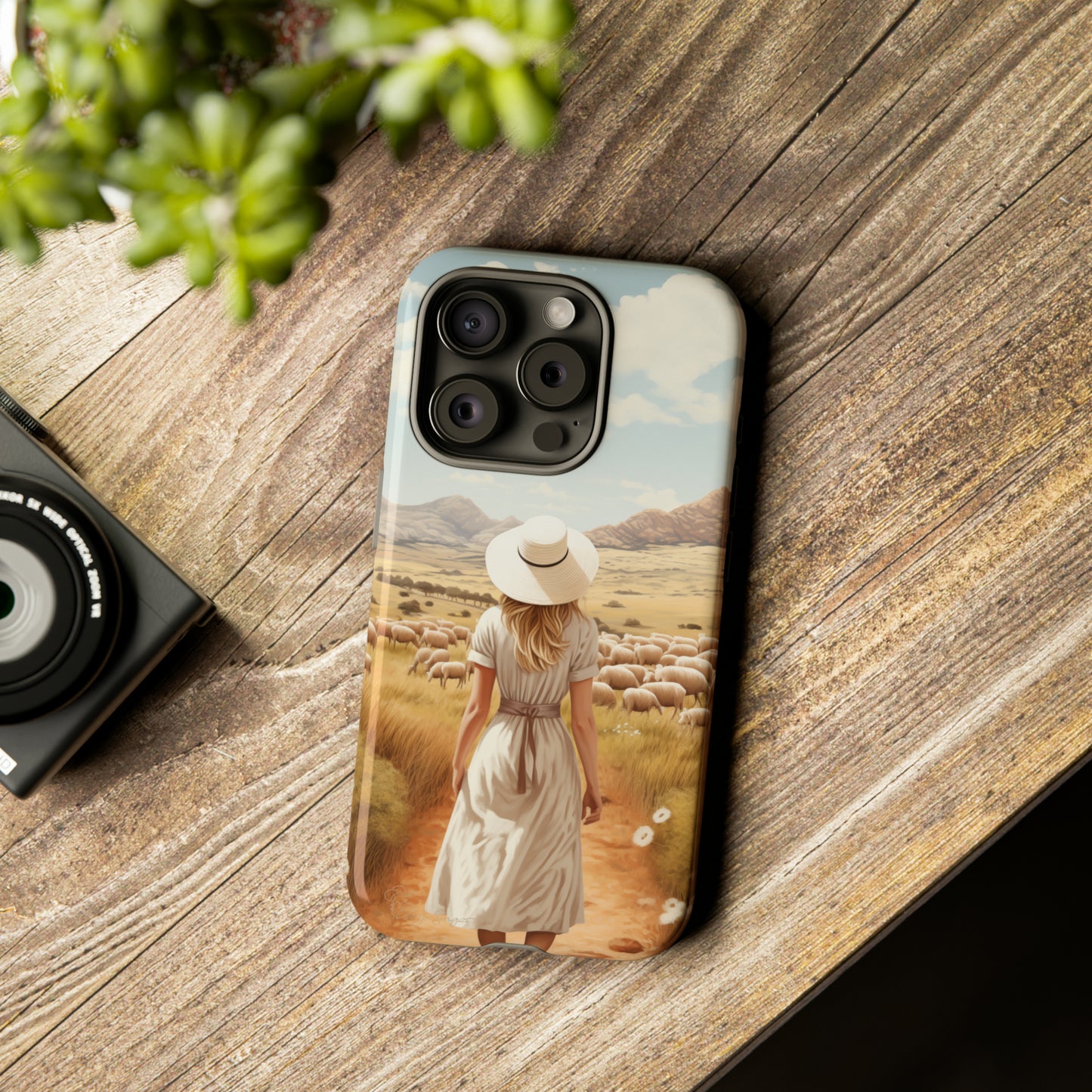 Dreamy Nostalgia: Immerse yourself in a vintage painted landscape with our Tough Western Cell Phone Case. Adorned with a woman in a hat strolling through a prairie with sheep, this edition captures the magic of the past. Elevate your phone with timeless charm. #ElizaSinger #PhoneCase
