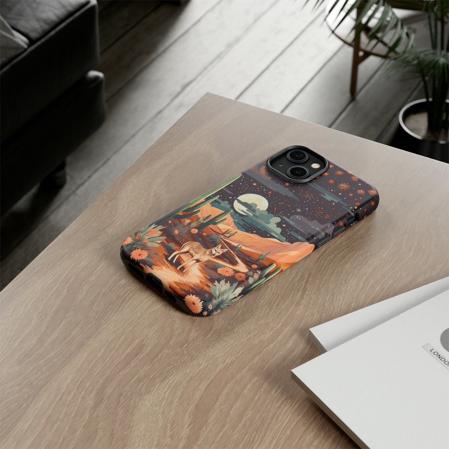 Introducing our Tough Western Cell Phone Case: Twilight Desert Jackal Remix Edition! A variation of our popular design, this edition features a jackal in a desert landscape with a starry night sky and cacti. Get ready for a unique twist on classic rugged protection.