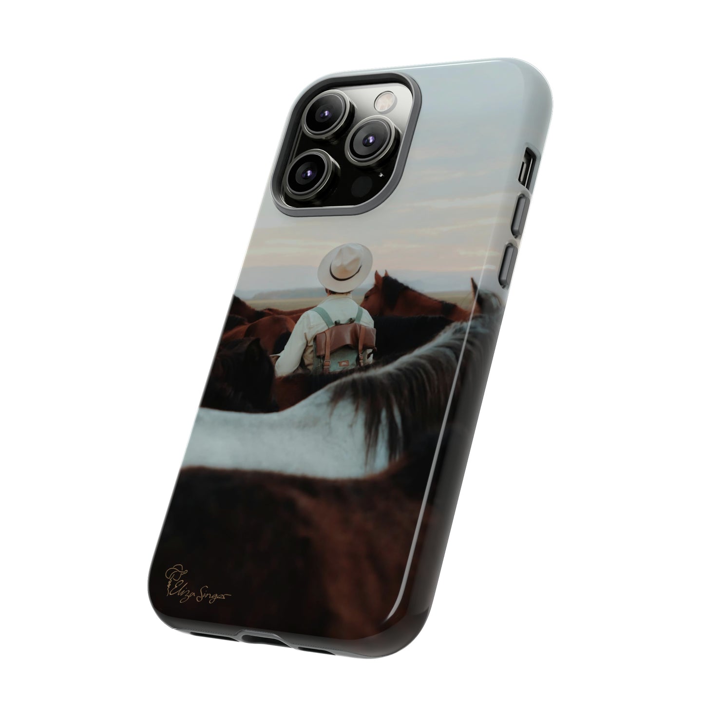 Ride into the Wild: Horse Art Western Photo Yellowstone Design iPhone Tough Protective Cover. Featuring a Cowboy amidst Mountains and Buckskin hues. Compatible with iPhone 15, 14, 13, XS, XR Pro/Max/Mini/P/Plus. Embrace the Spirit of the West with Style and Durability. #ElizaSinger #PhoneCase #WesternDesign