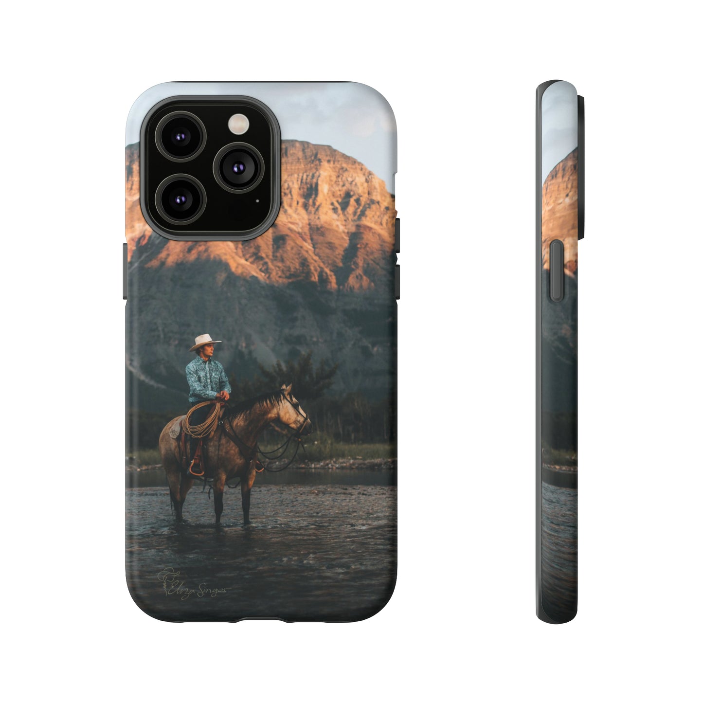 Capture the Wild: Horse Art Western Photo Yellowstone Design iPhone Tough Protective Cover. Featuring a Cowboy amidst Mountains and Buckskin hues, compatible with iPhone 15, 14, 13, XS, XR Pro/Max/Mini/P/Plus. Embrace the Spirit of the West with Style and Durability. #ElizaSinger #PhoneCase #WesternDesign
