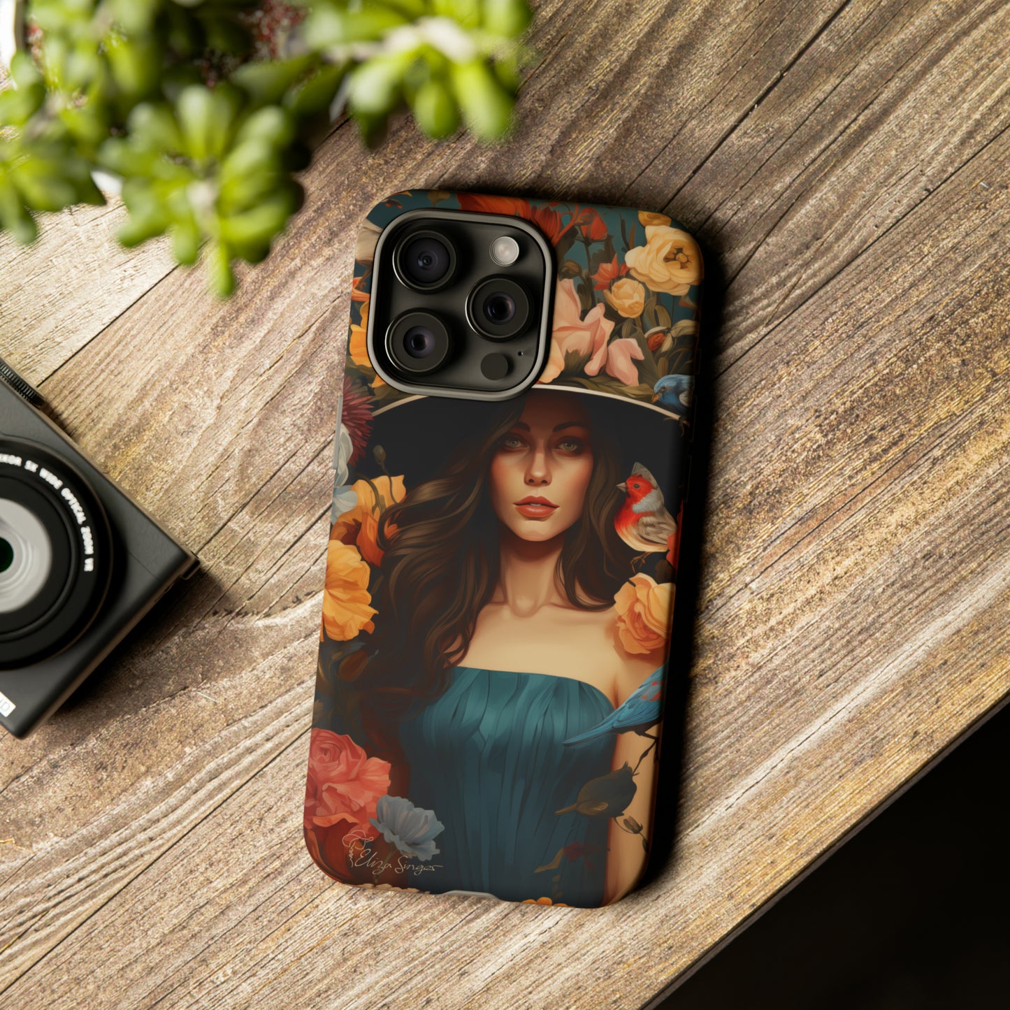 Dark Elegance Unveiled: Explore our Tough Cell Phone Case with a captivating dark background and a woman adorned with a hat amid blooming flowers. This edition seamlessly blends sophistication with robust protection, showcasing the allure of dark elegance. Elevate your style and shield your device. #ElizaSinger #PhoneCase #ElegantProtection