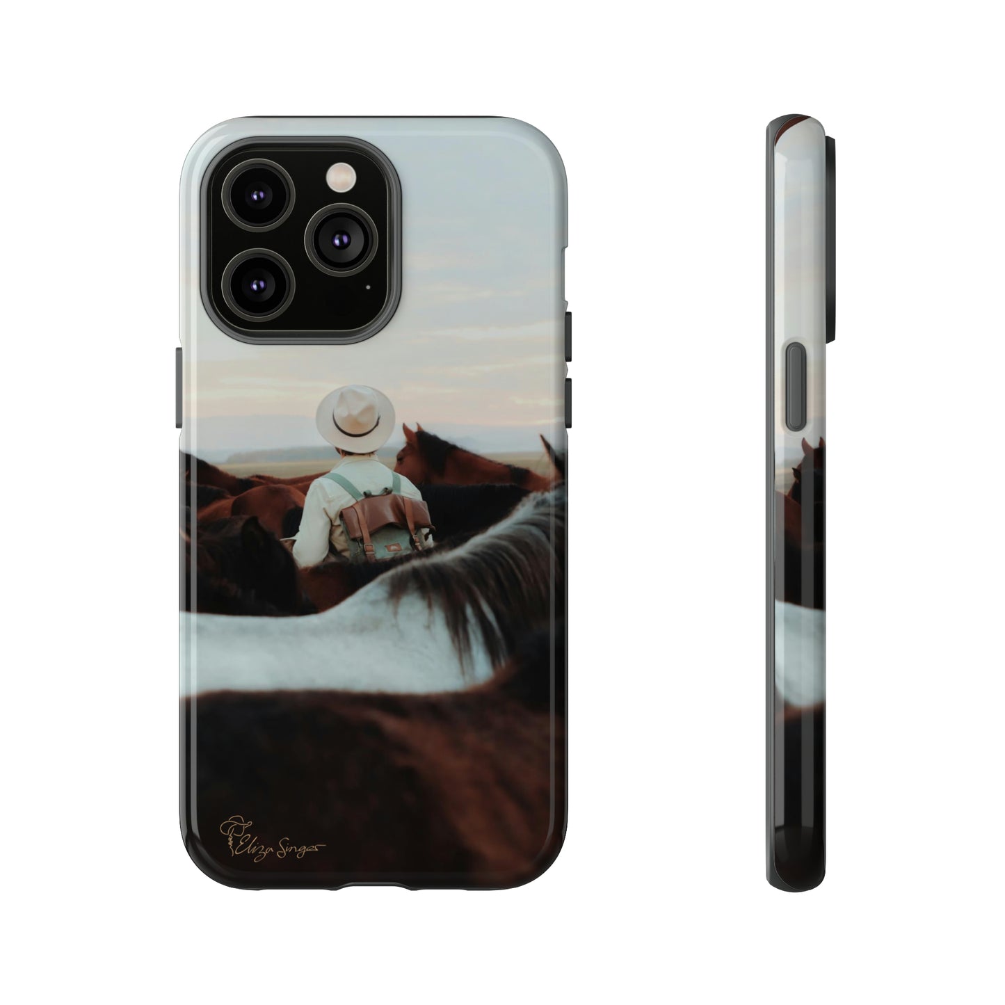 Ride into the Wild: Horse Art Western Photo Yellowstone Design iPhone Tough Protective Cover. Featuring a Cowboy amidst Mountains and Buckskin hues. Compatible with iPhone 15, 14, 13, XS, XR Pro/Max/Mini/P/Plus. Embrace the Spirit of the West with Style and Durability. #ElizaSinger #PhoneCase #WesternDesign