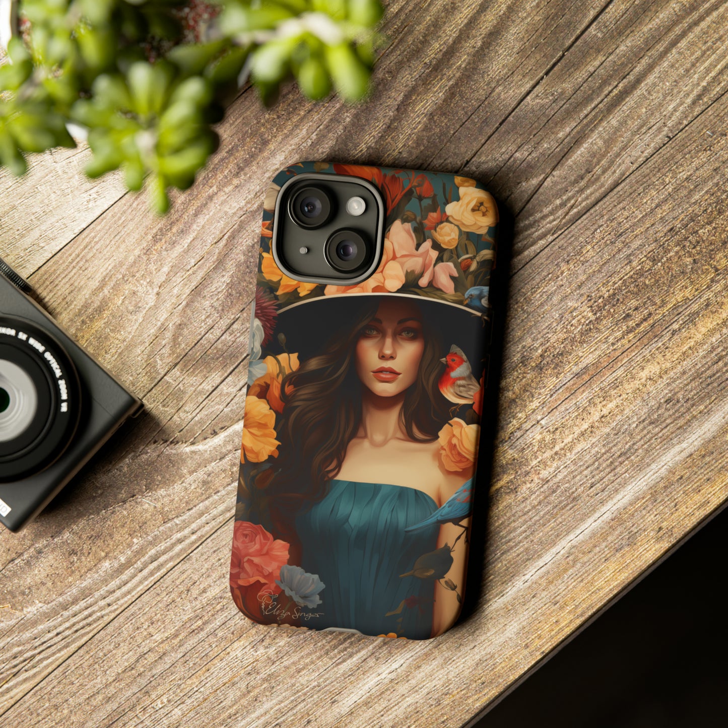 Dark Elegance Unveiled: Explore our Tough Cell Phone Case with a captivating dark background and a woman adorned with a hat amid blooming flowers. This edition seamlessly blends sophistication with robust protection, showcasing the allure of dark elegance. Elevate your style and shield your device. #ElizaSinger #PhoneCase #ElegantProtection