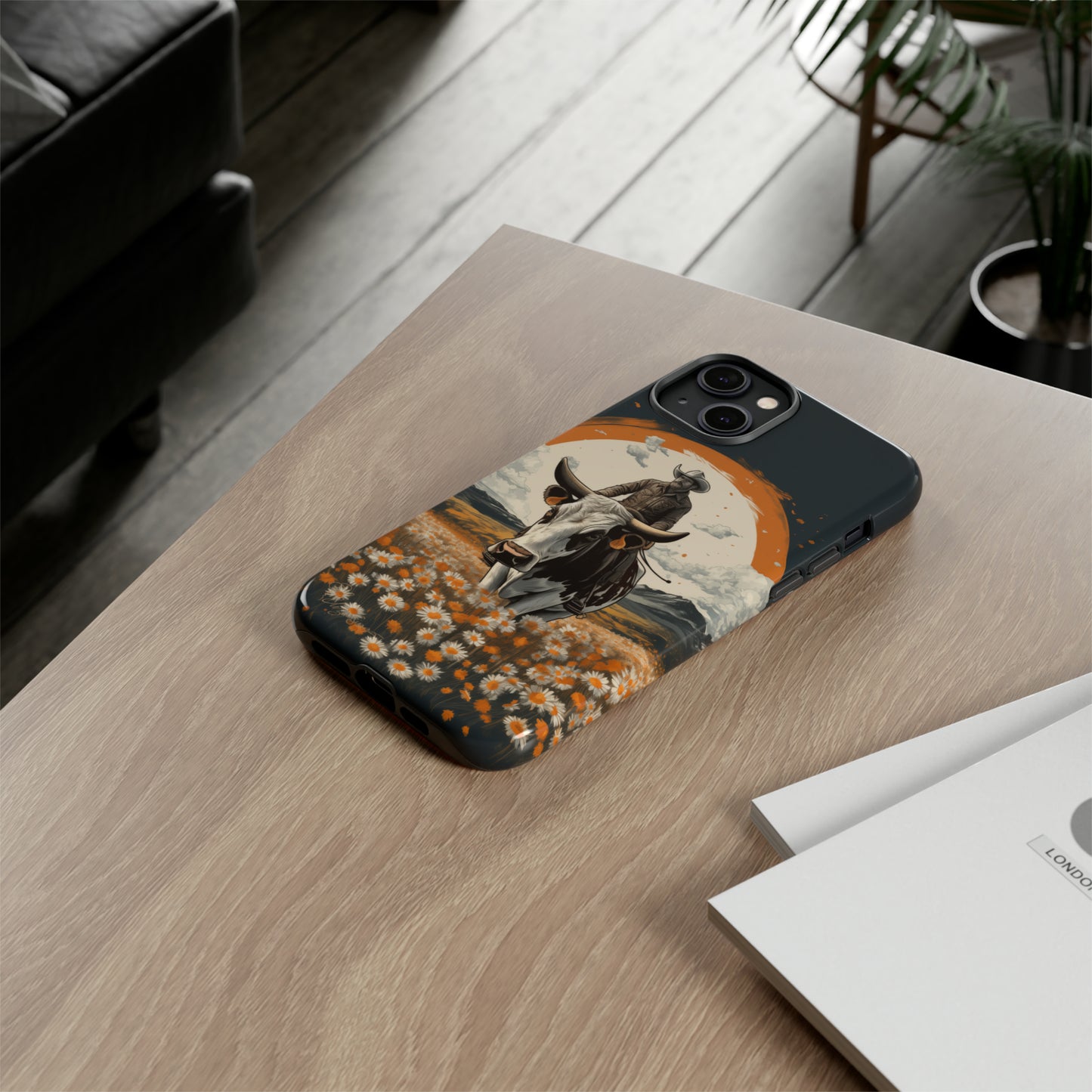 Meet 'Rugged Wrangler': Introducing our Tough Western Cell Phone Case. This unique design seamlessly combines rugged protection with a touch of whimsy, showcasing a fearless cowboy astride a dairy cow amidst a field of vibrant daisies. Elevate your style with this adventurous and protective accessory. #ElizaSinger #PhoneCase #RuggedWrangler