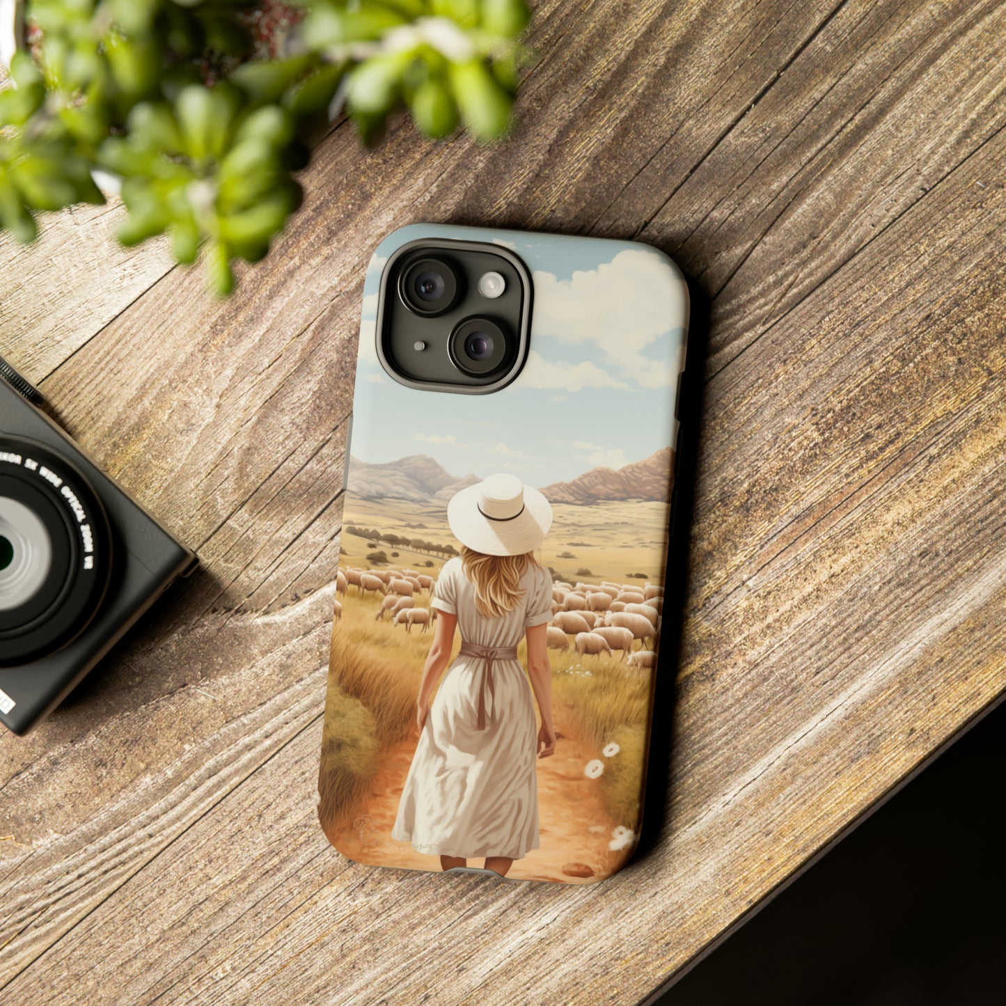 Dreamy Nostalgia: Immerse yourself in a vintage painted landscape with our Tough Western Cell Phone Case. Adorned with a woman in a hat strolling through a prairie with sheep, this edition captures the magic of the past. Elevate your phone with timeless charm. #ElizaSinger #PhoneCase
