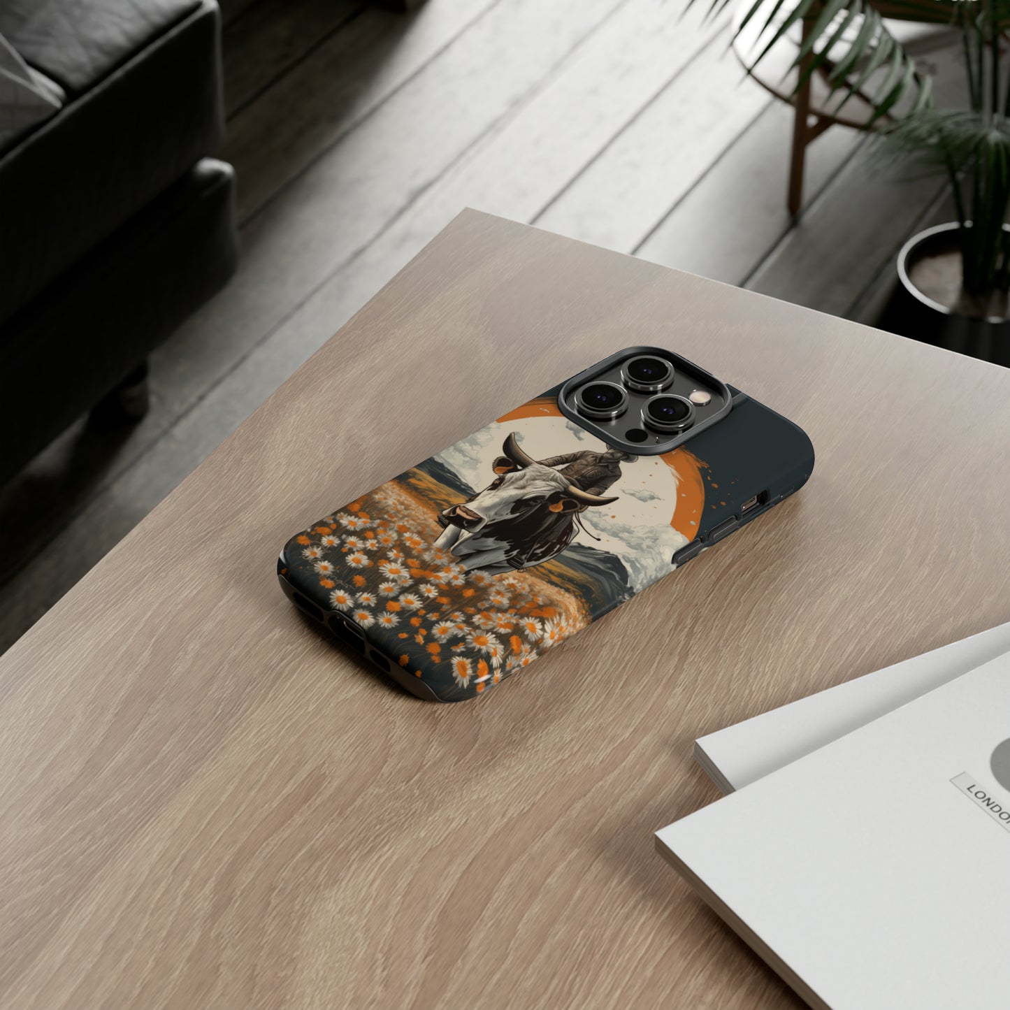 Meet 'Rugged Wrangler': Introducing our Tough Western Cell Phone Case. This unique design seamlessly combines rugged protection with a touch of whimsy, showcasing a fearless cowboy astride a dairy cow amidst a field of vibrant daisies. Elevate your style with this adventurous and protective accessory. #ElizaSinger #PhoneCase #RuggedWrangler