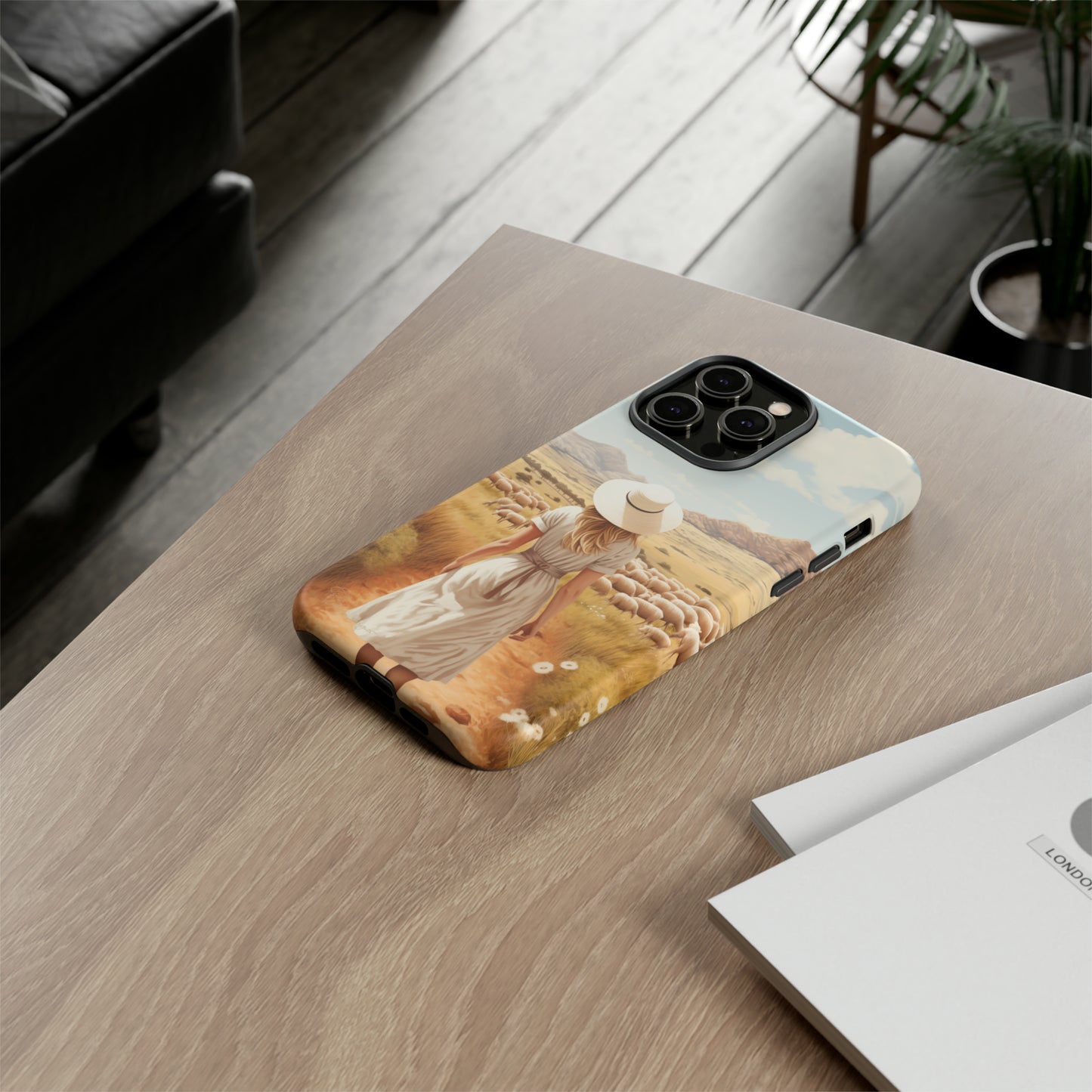 Dreamy Nostalgia: Immerse yourself in a vintage painted landscape with our Tough Western Cell Phone Case. Adorned with a woman in a hat strolling through a prairie with sheep, this edition captures the magic of the past. Elevate your phone with timeless charm. #ElizaSinger #PhoneCase