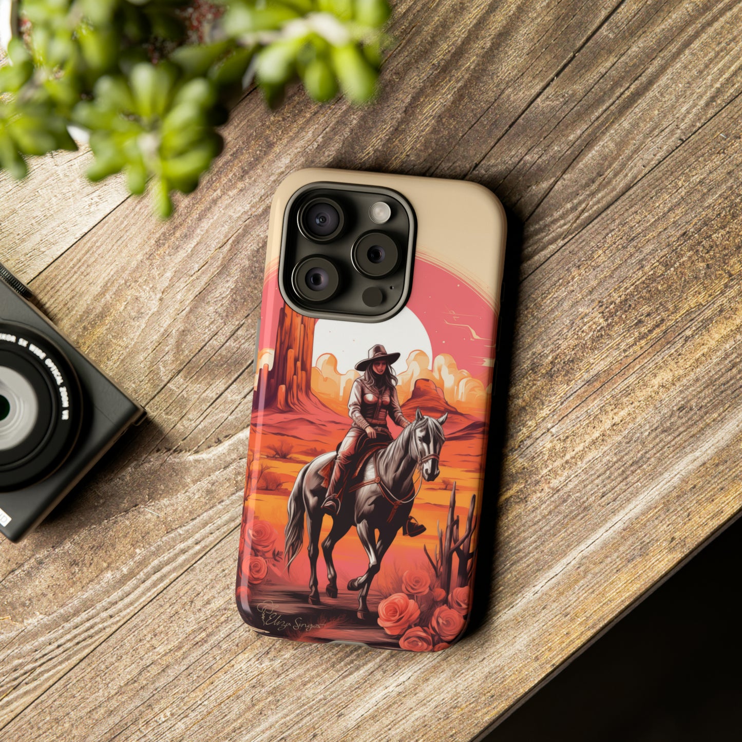 Feminine Adventure Unleashed: Introducing our Tough Western Cell Phone Case, adorned with a stunning design of a cowgirl riding a horse through the desert, surrounded by shades of coral. This unique edition seamlessly combines rugged protection with a touch of feminine flair. Elevate your style with a dash of adventurous charm. #ElizaSinger #PhoneCase #FeminineAdventure