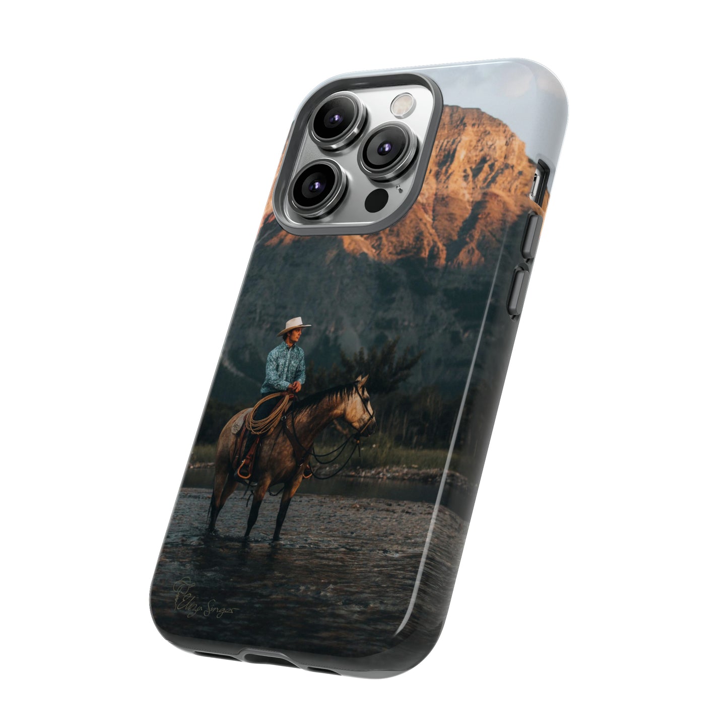 Capture the Wild: Horse Art Western Photo Yellowstone Design iPhone Tough Protective Cover. Featuring a Cowboy amidst Mountains and Buckskin hues, compatible with iPhone 15, 14, 13, XS, XR Pro/Max/Mini/P/Plus. Embrace the Spirit of the West with Style and Durability. #ElizaSinger #PhoneCase #WesternDesign