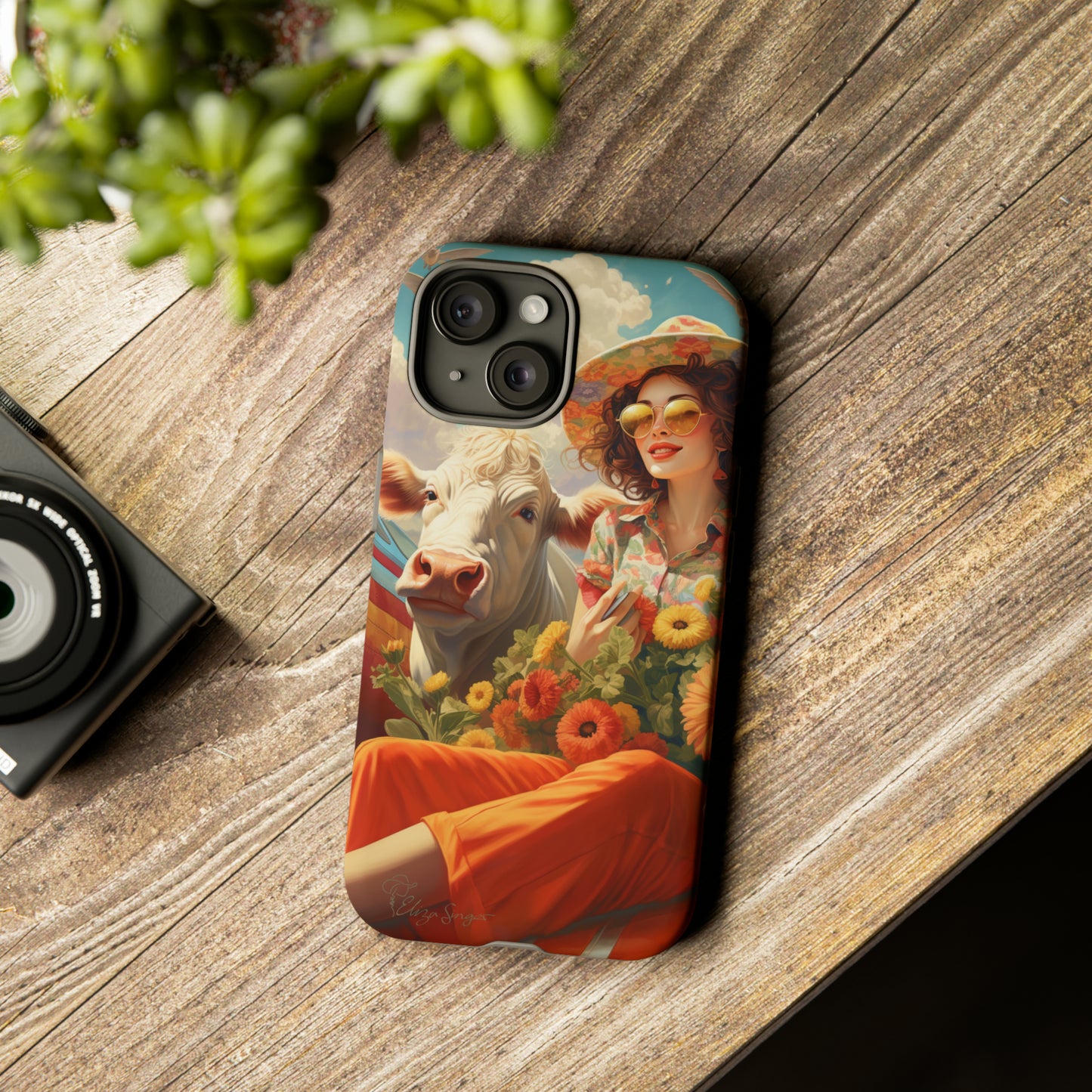 Timeless Retro Charm: Step back in time with our Tough Western Cell Phone Case. Featuring a vintage and bright design, a woman in a hat with daisies is accompanied by a cow looking over her shoulder. Experience the perfect blend of retro aesthetics and durability. Elevate your style with a touch of nostalgia. #ElizaSinger #PhoneCase #RetroStyle