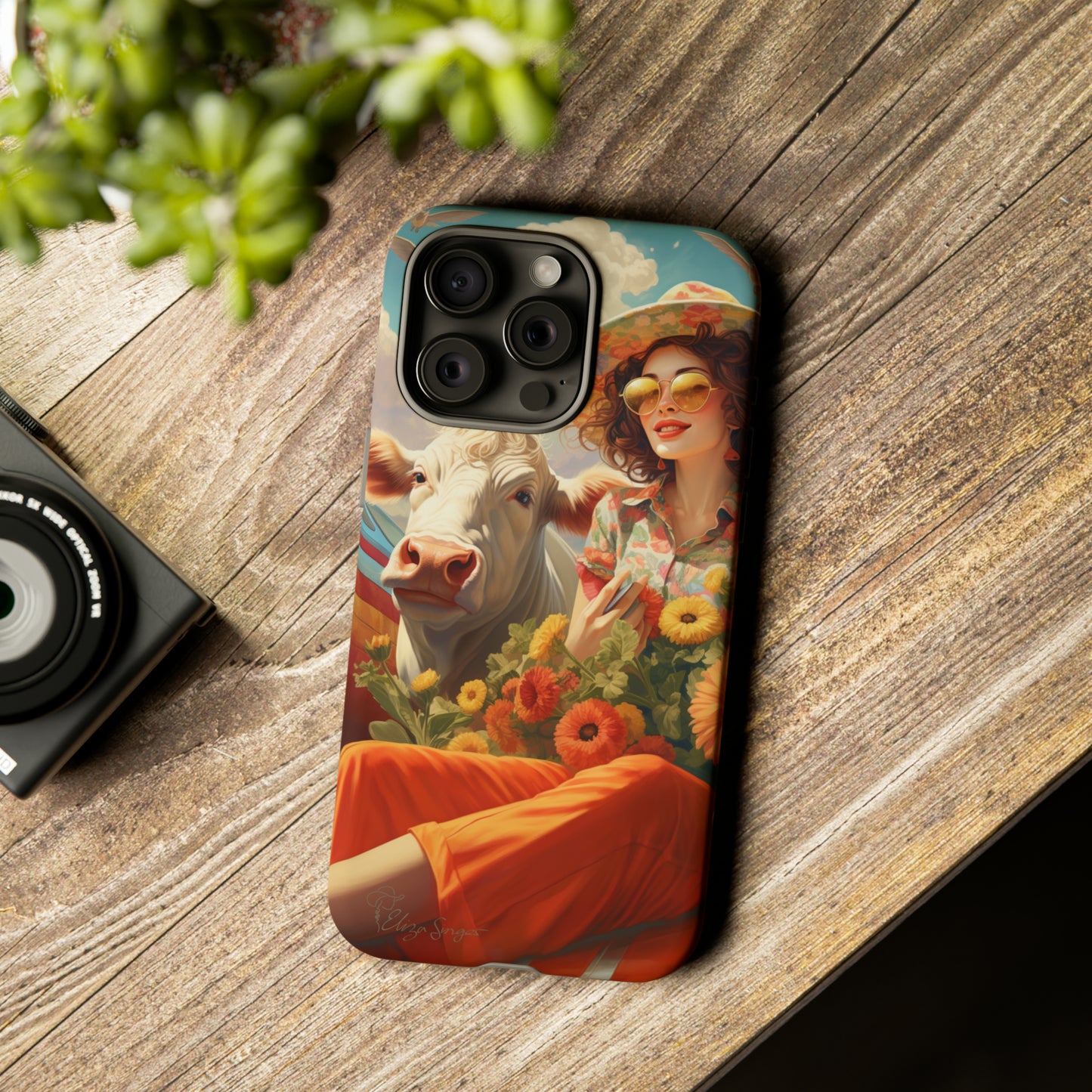 Timeless Retro Charm: Step back in time with our Tough Western Cell Phone Case. Featuring a vintage and bright design, a woman in a hat with daisies is accompanied by a cow looking over her shoulder. Experience the perfect blend of retro aesthetics and durability. Elevate your style with a touch of nostalgia. #ElizaSinger #PhoneCase #RetroStyle