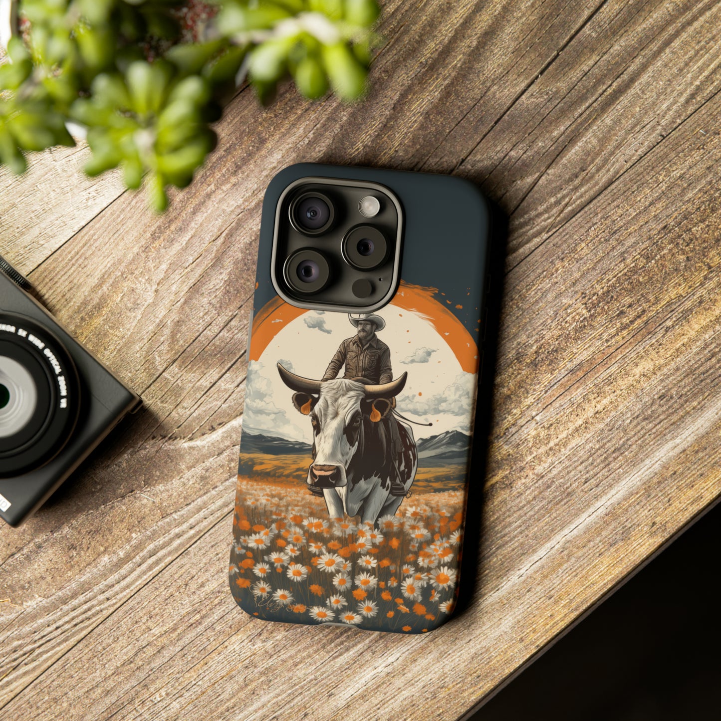 Meet 'Rugged Wrangler': Introducing our Tough Western Cell Phone Case. This unique design seamlessly combines rugged protection with a touch of whimsy, showcasing a fearless cowboy astride a dairy cow amidst a field of vibrant daisies. Elevate your style with this adventurous and protective accessory. #ElizaSinger #PhoneCase #RuggedWrangler