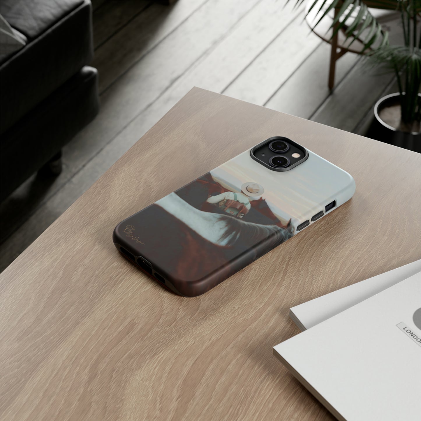 Ride into the Wild: Horse Art Western Photo Yellowstone Design iPhone Tough Protective Cover. Featuring a Cowboy amidst Mountains and Buckskin hues. Compatible with iPhone 15, 14, 13, XS, XR Pro/Max/Mini/P/Plus. Embrace the Spirit of the West with Style and Durability. #ElizaSinger #PhoneCase #WesternDesign