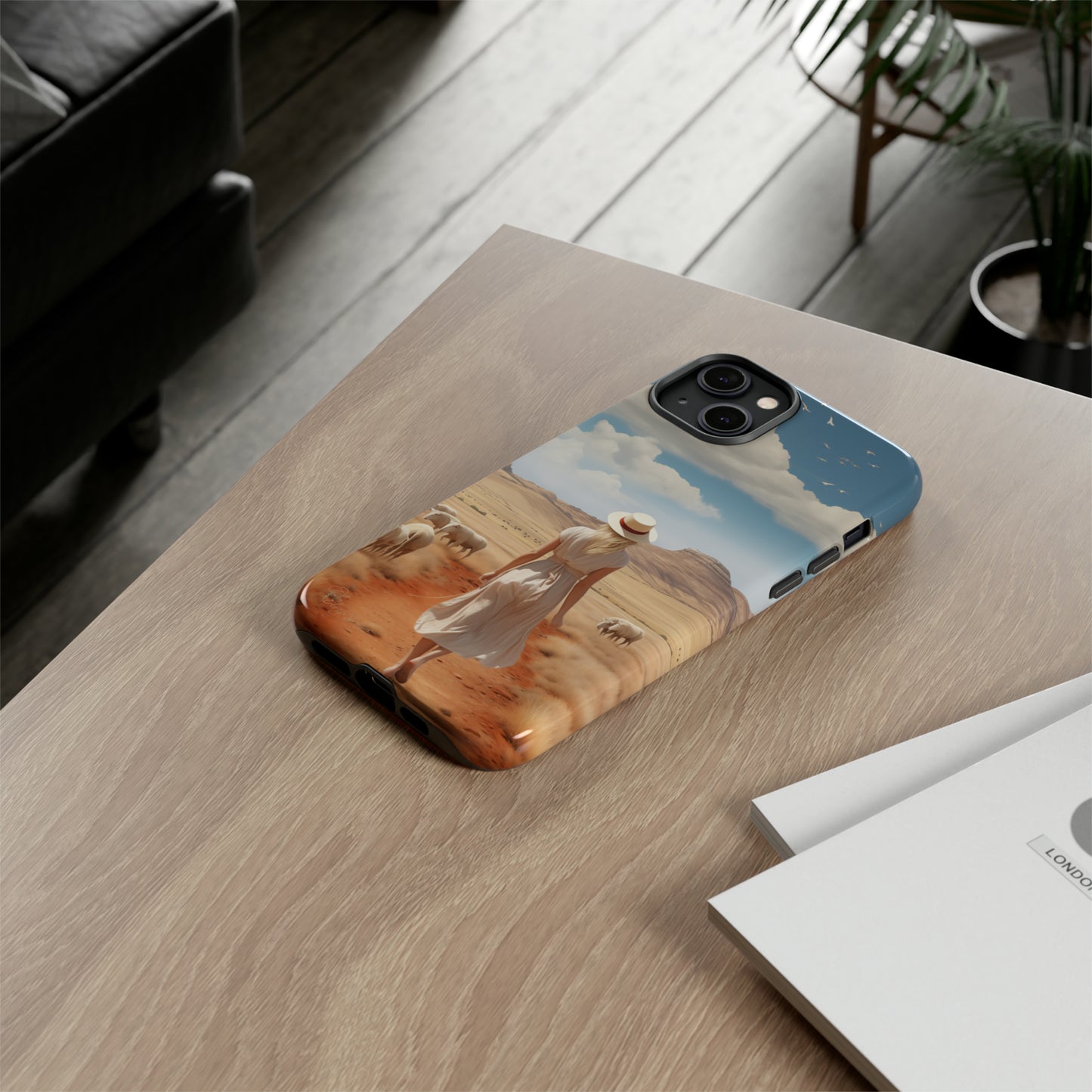 Serenity in Hand: Our Tough Western Cell Phone Case invites you to experience tranquility. A vintage painted design portrays a woman in a skirt and hat walking on a dirt road through a prairie, with grazing sheep. Let the vanishing horizon captivate your senses. Elevate your phone with timeless beauty. #ElizaSinger #PhoneCase