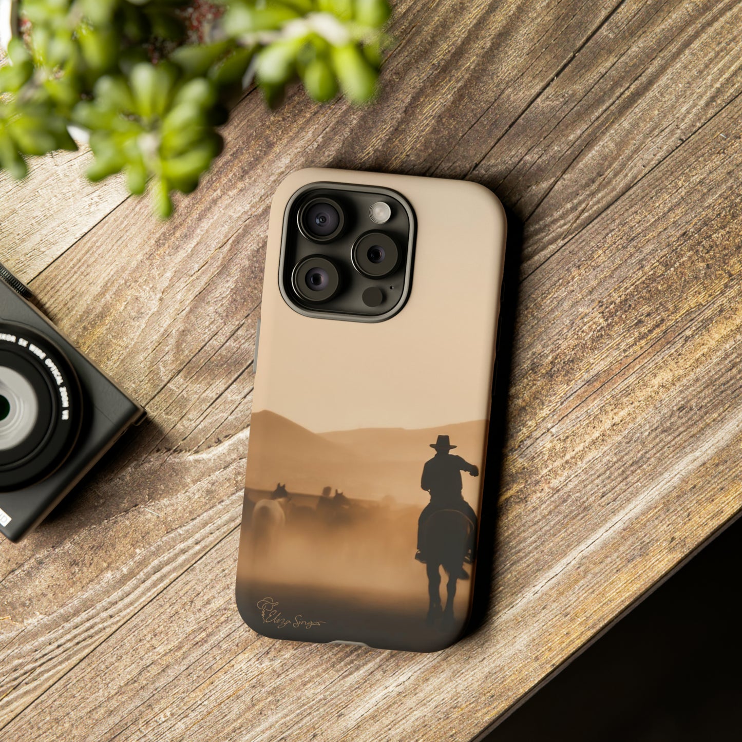 Capture the Western Spirit: Horse Art Western Photo Yellowstone Design iPhone Tough Protective Cover. Featuring a Cowboy amidst Mountains and Buckskin hues. Compatible with iPhone 15, 14, 13, XS, XR Pro/Max/Mini/P/Plus. Bring the Wild West to Your Device with Style and Durability. #ElizaSinger #PhoneCase #WesternDesign