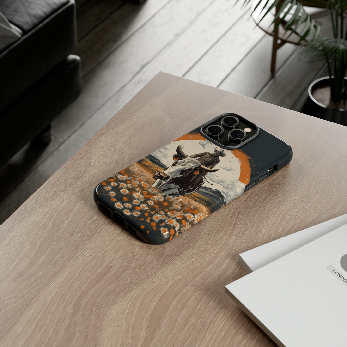 Meet 'Rugged Wrangler': Introducing our Tough Western Cell Phone Case. This unique design seamlessly combines rugged protection with a touch of whimsy, showcasing a fearless cowboy astride a dairy cow amidst a field of vibrant daisies. Elevate your style with this adventurous and protective accessory. #ElizaSinger #PhoneCase #RuggedWrangler