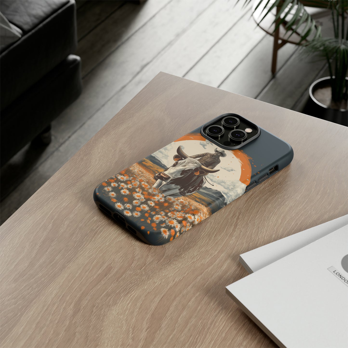 Meet 'Rugged Wrangler': Introducing our Tough Western Cell Phone Case. This unique design seamlessly combines rugged protection with a touch of whimsy, showcasing a fearless cowboy astride a dairy cow amidst a field of vibrant daisies. Elevate your style with this adventurous and protective accessory. #ElizaSinger #PhoneCase #RuggedWrangler