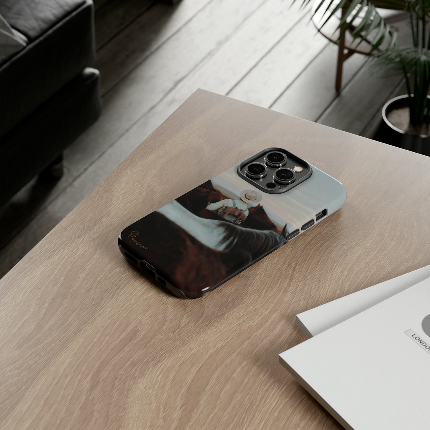 Ride into the Wild: Horse Art Western Photo Yellowstone Design iPhone Tough Protective Cover. Featuring a Cowboy amidst Mountains and Buckskin hues. Compatible with iPhone 15, 14, 13, XS, XR Pro/Max/Mini/P/Plus. Embrace the Spirit of the West with Style and Durability. #ElizaSinger #PhoneCase #WesternDesign