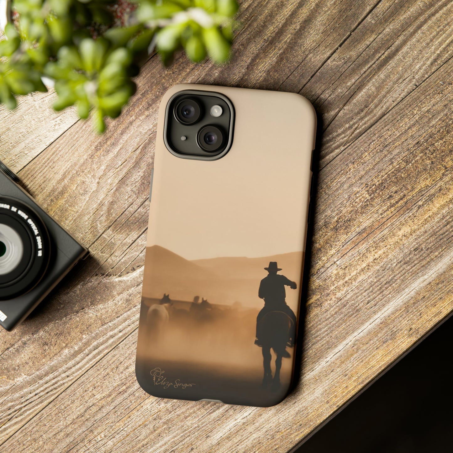Capture the Western Spirit: Horse Art Western Photo Yellowstone Design iPhone Tough Protective Cover. Featuring a Cowboy amidst Mountains and Buckskin hues. Compatible with iPhone 15, 14, 13, XS, XR Pro/Max/Mini/P/Plus. Bring the Wild West to Your Device with Style and Durability. #ElizaSinger #PhoneCase #WesternDesign