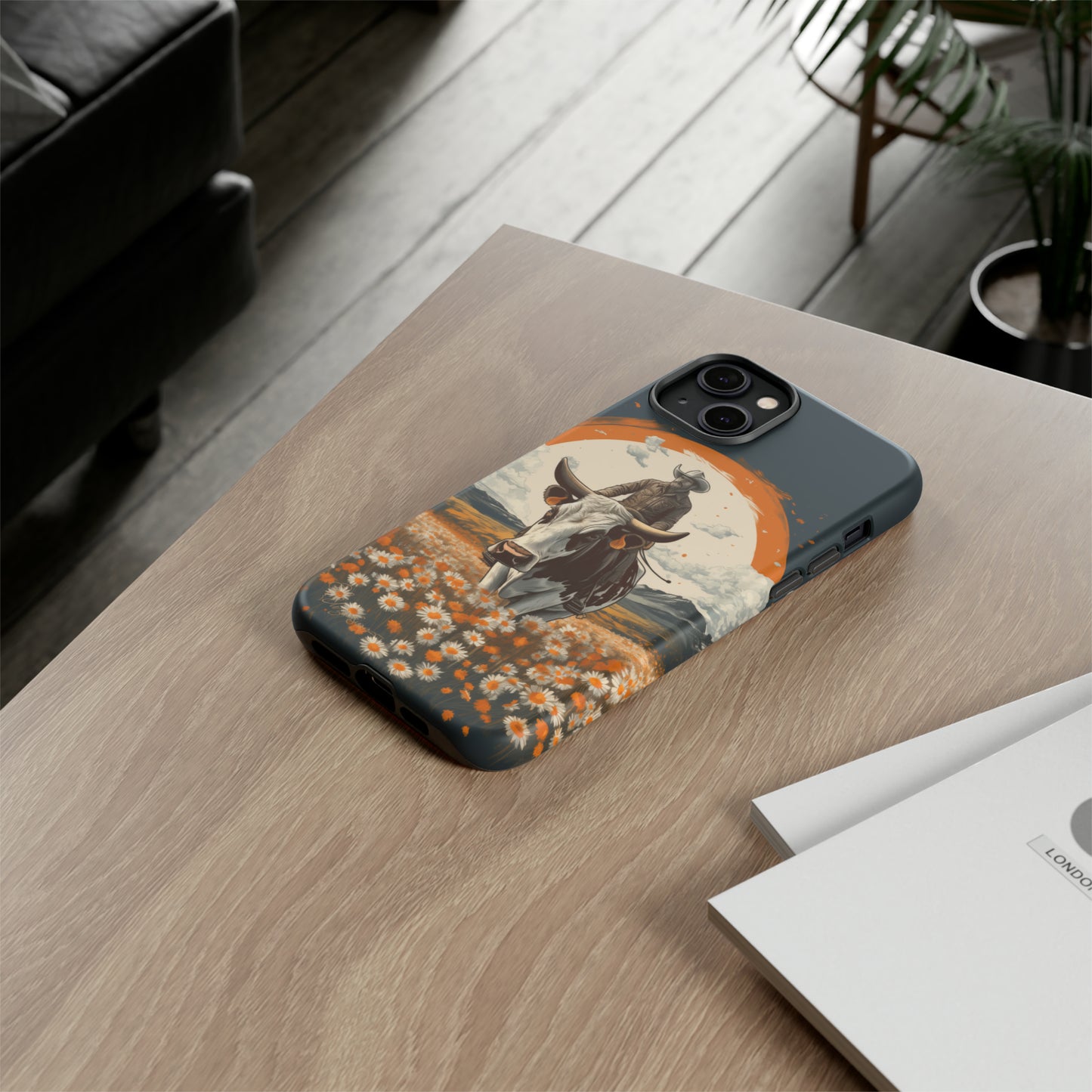 Meet 'Rugged Wrangler': Introducing our Tough Western Cell Phone Case. This unique design seamlessly combines rugged protection with a touch of whimsy, showcasing a fearless cowboy astride a dairy cow amidst a field of vibrant daisies. Elevate your style with this adventurous and protective accessory. #ElizaSinger #PhoneCase #RuggedWrangler