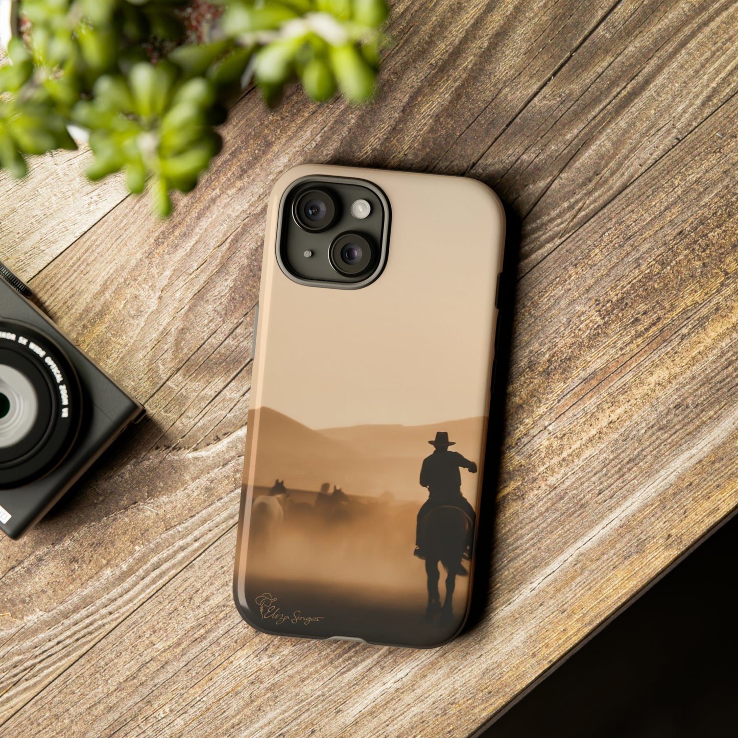 Capture the Western Spirit: Horse Art Western Photo Yellowstone Design iPhone Tough Protective Cover. Featuring a Cowboy amidst Mountains and Buckskin hues. Compatible with iPhone 15, 14, 13, XS, XR Pro/Max/Mini/P/Plus. Bring the Wild West to Your Device with Style and Durability. #ElizaSinger #PhoneCase #WesternDesign