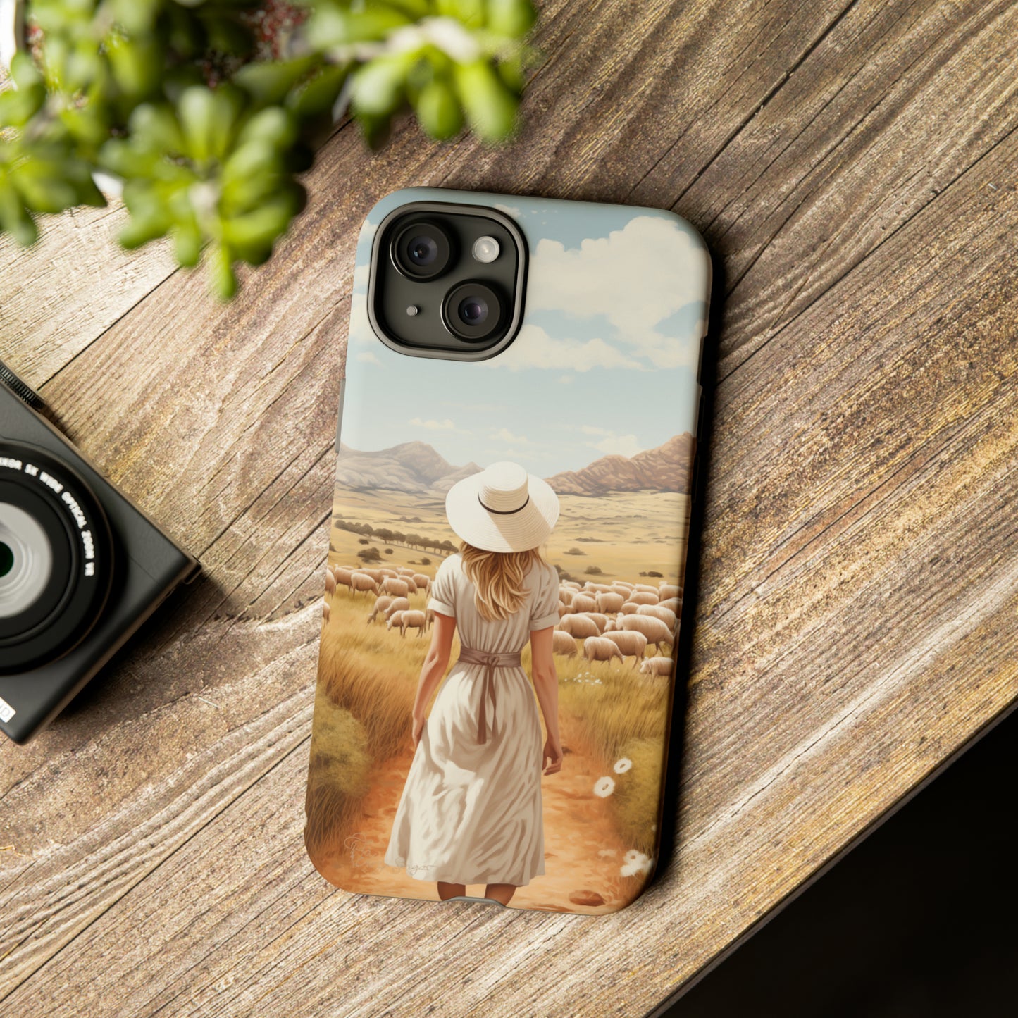 Dreamy Nostalgia: Immerse yourself in a vintage painted landscape with our Tough Western Cell Phone Case. Adorned with a woman in a hat strolling through a prairie with sheep, this edition captures the magic of the past. Elevate your phone with timeless charm. #ElizaSinger #PhoneCase