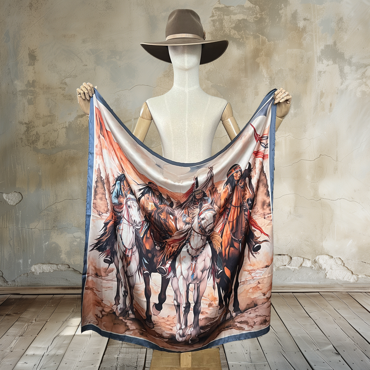 Embark on a journey with Desert Riders Wild Rag. Four Native Americans on horseback traverse a desert landscape on this 39" square of 100% satin silk. Elevate your style with this captivating and culturally inspired accessory.
