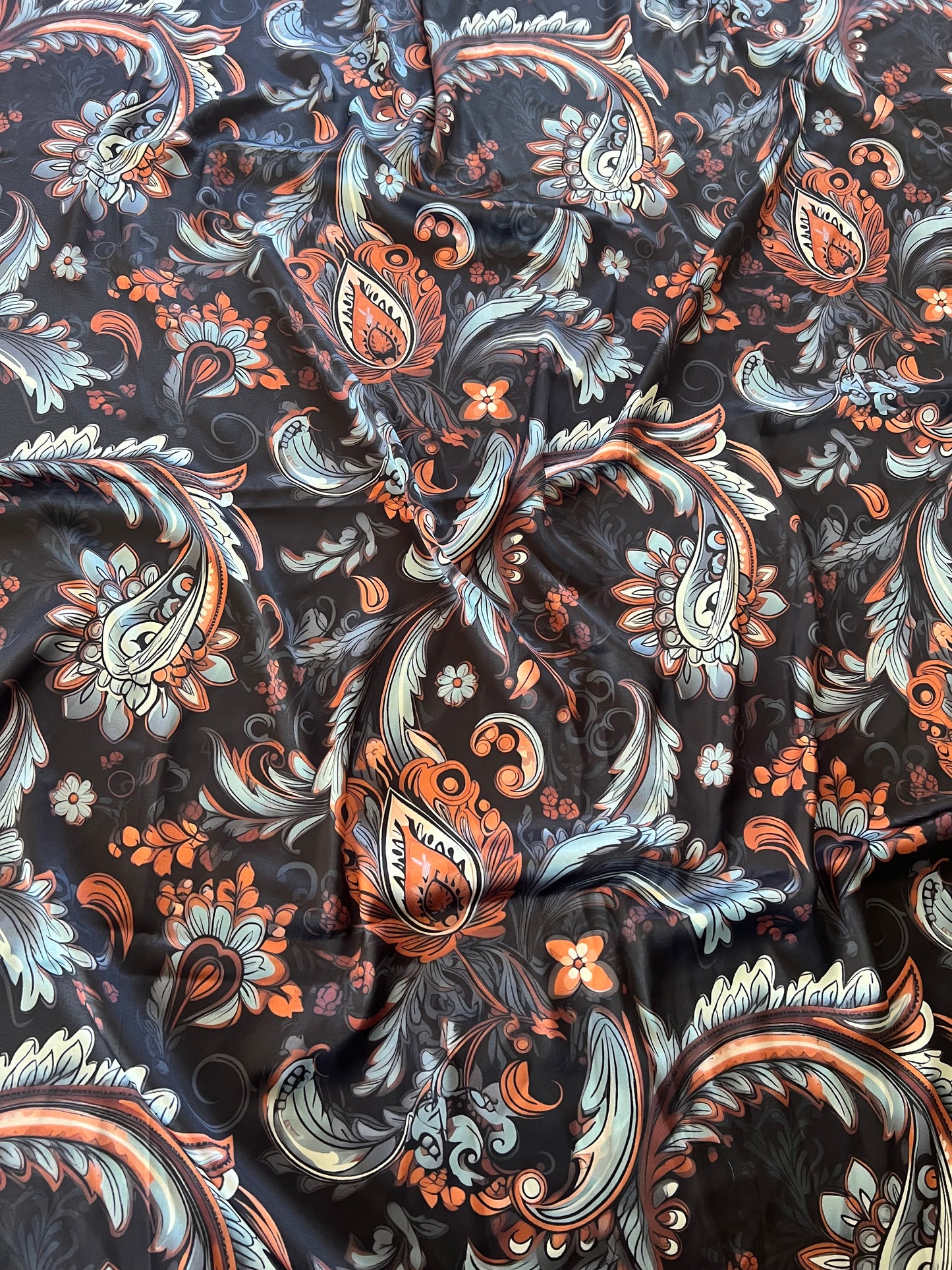 A modern paisley wild rag in rich black and rust tones. Luxurious satin silk with Eliza Singer’s signature in the corner.