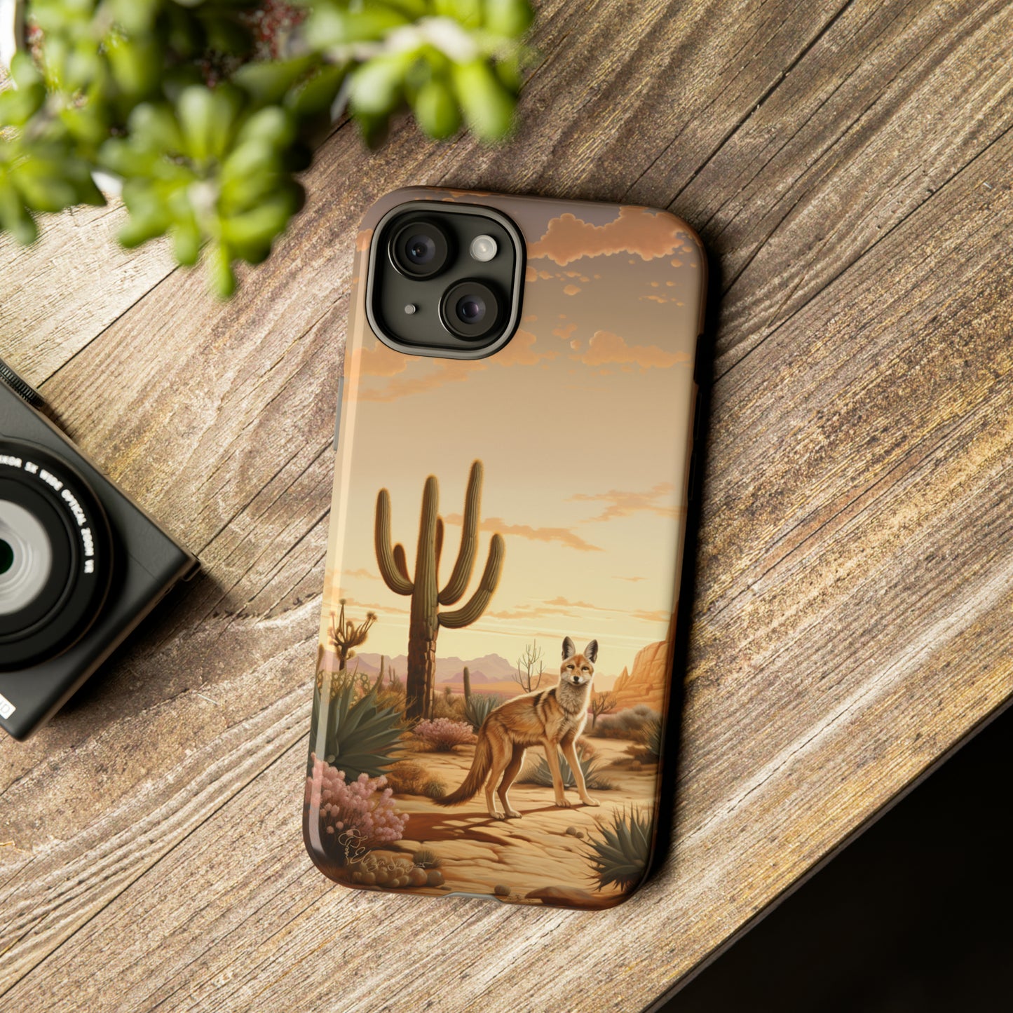 Unveiling our Western Tough Cell Phone Case: Dusk Jackal Oasis Edition! Witness the beauty of dusk with a jackal in a desert landscape next to a cactus. This design offers both rugged protection and a touch of twilight elegance.