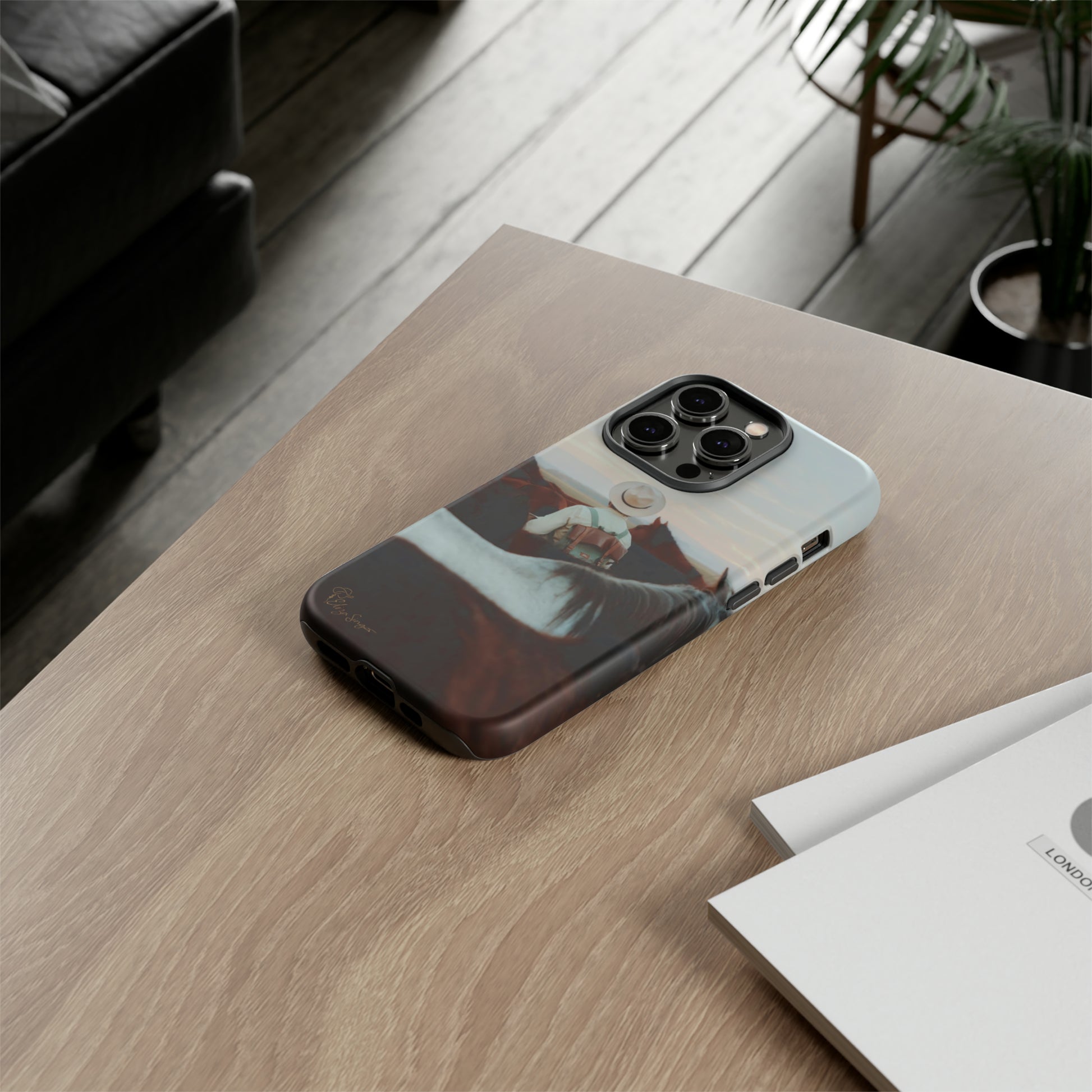Ride into the Wild: Horse Art Western Photo Yellowstone Design iPhone Tough Protective Cover. Featuring a Cowboy amidst Mountains and Buckskin hues. Compatible with iPhone 15, 14, 13, XS, XR Pro/Max/Mini/P/Plus. Embrace the Spirit of the West with Style and Durability. #ElizaSinger #PhoneCase #WesternDesign