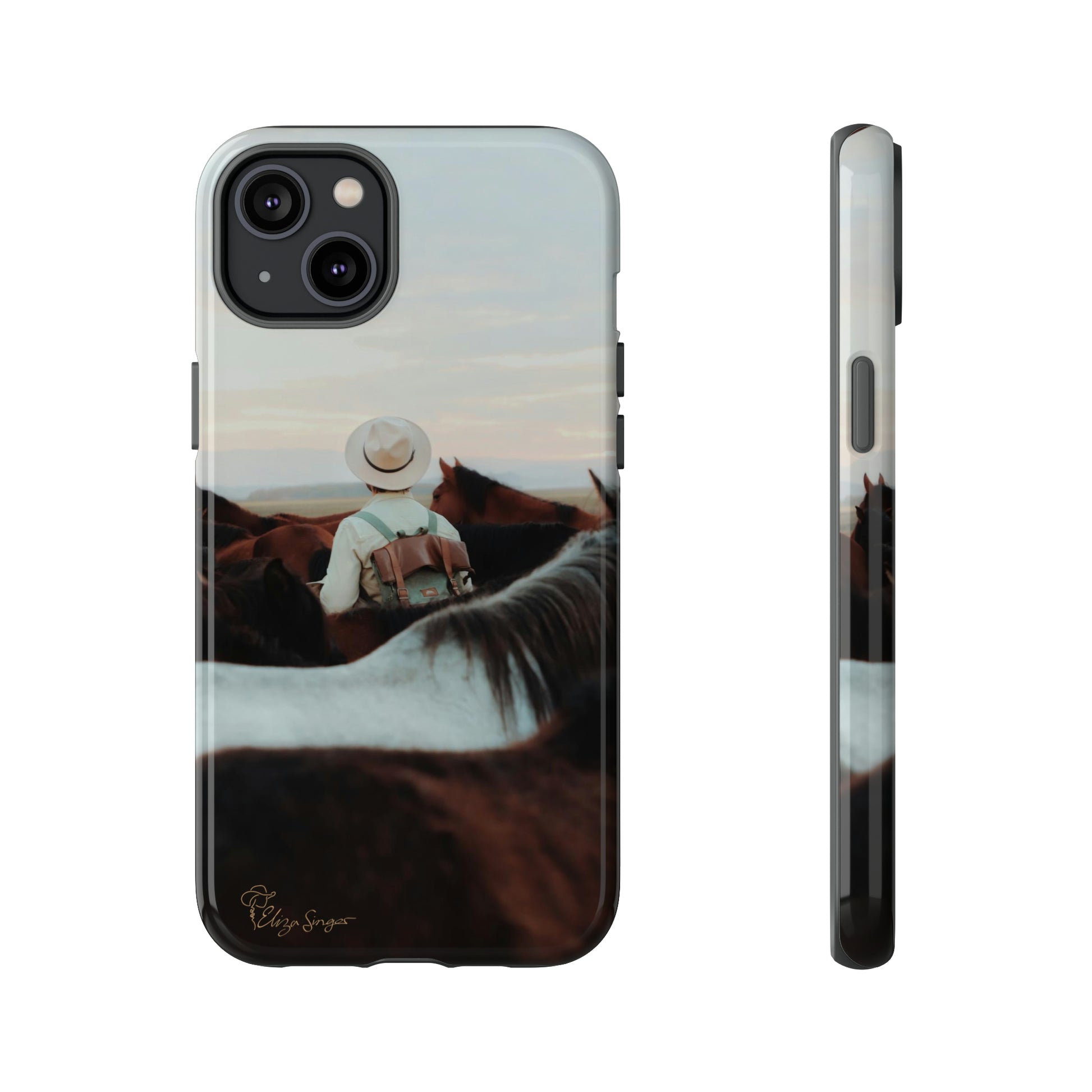 Ride into the Wild: Horse Art Western Photo Yellowstone Design iPhone Tough Protective Cover. Featuring a Cowboy amidst Mountains and Buckskin hues. Compatible with iPhone 15, 14, 13, XS, XR Pro/Max/Mini/P/Plus. Embrace the Spirit of the West with Style and Durability. #ElizaSinger #PhoneCase #WesternDesign