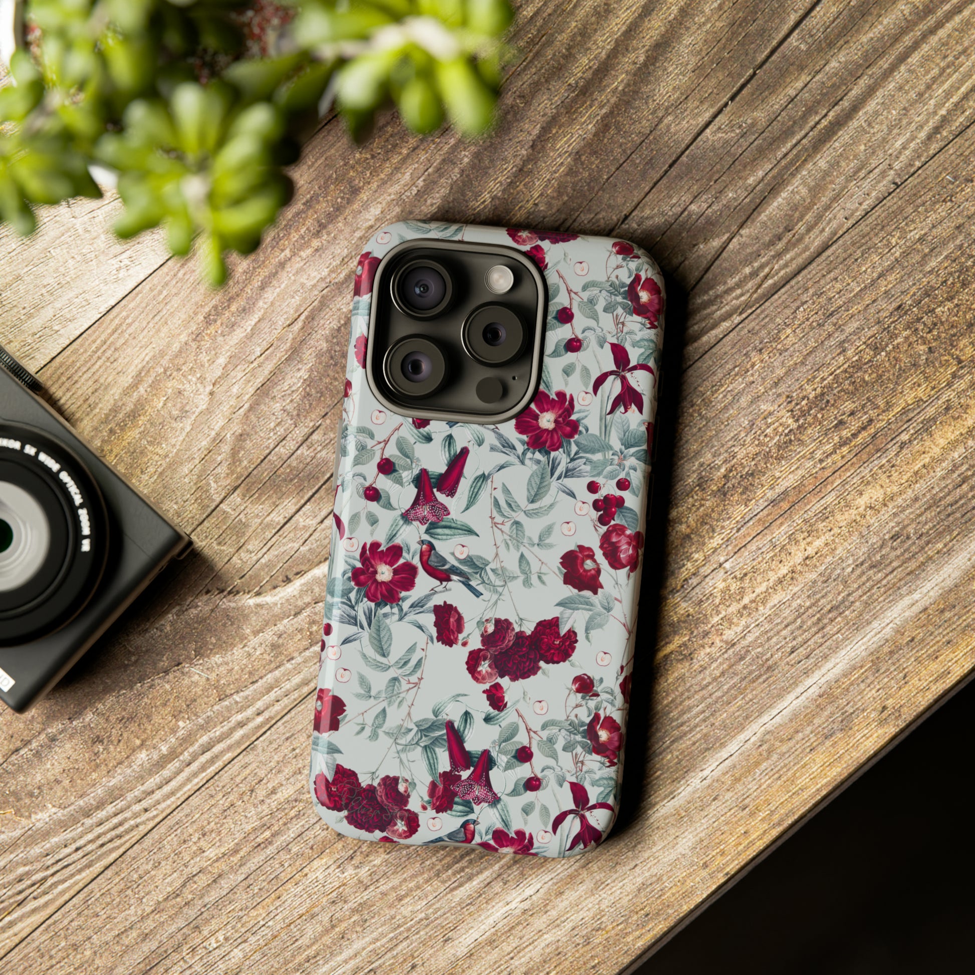Cherry Blossom Serenade: Cherish nature's beauty with 'Cherry Blossom Serenade.' This iPhone case features flowers and burgundy birds on a blue background, creating a captivating floral wildlife bird and flower design. Elevate your device with this enchanting and stylish protective cover. #ElizaSinger #PhoneCase #FloralDesign