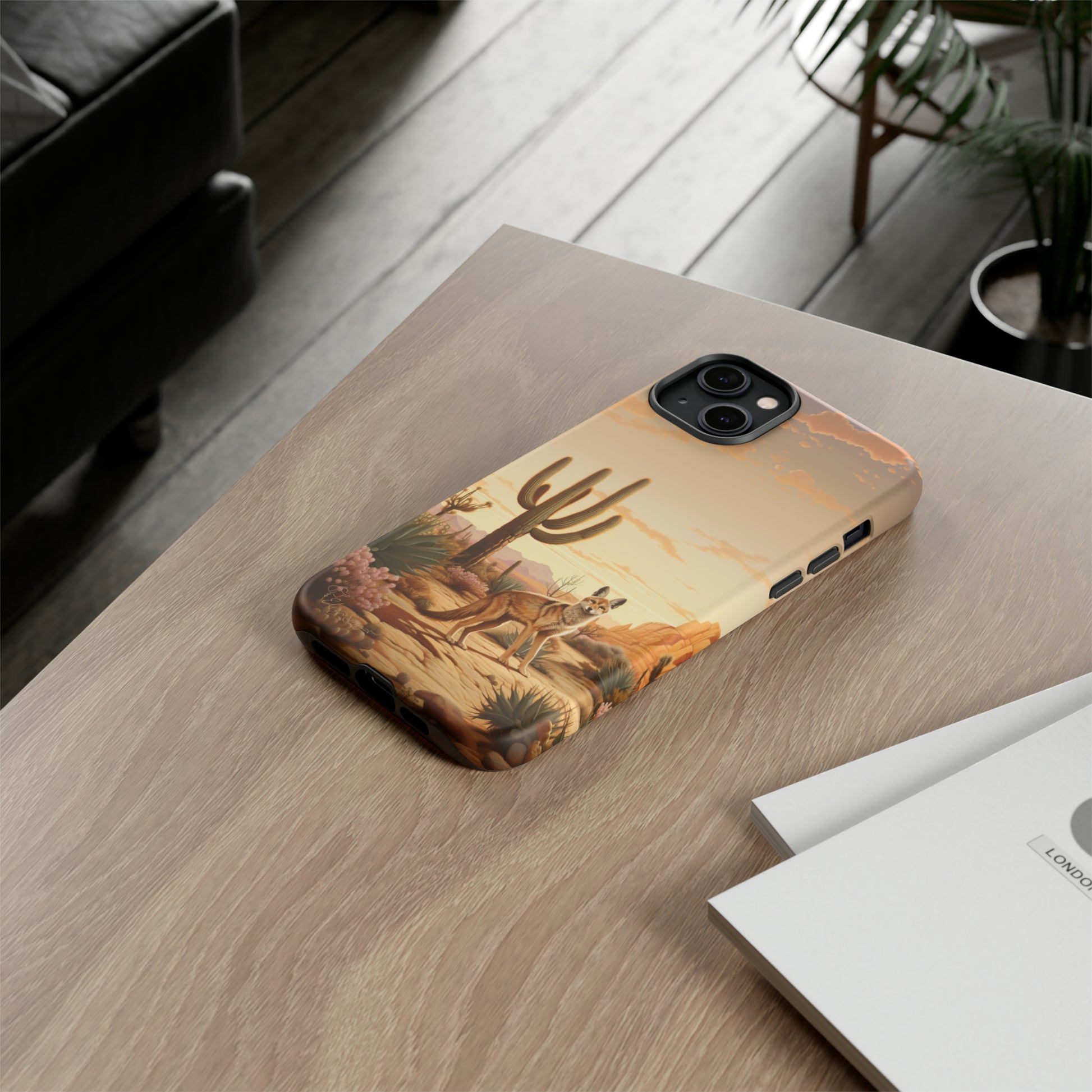 Unveiling our Western Tough Cell Phone Case: Dusk Jackal Oasis Edition! Witness the beauty of dusk with a jackal in a desert landscape next to a cactus. This design offers both rugged protection and a touch of twilight elegance.