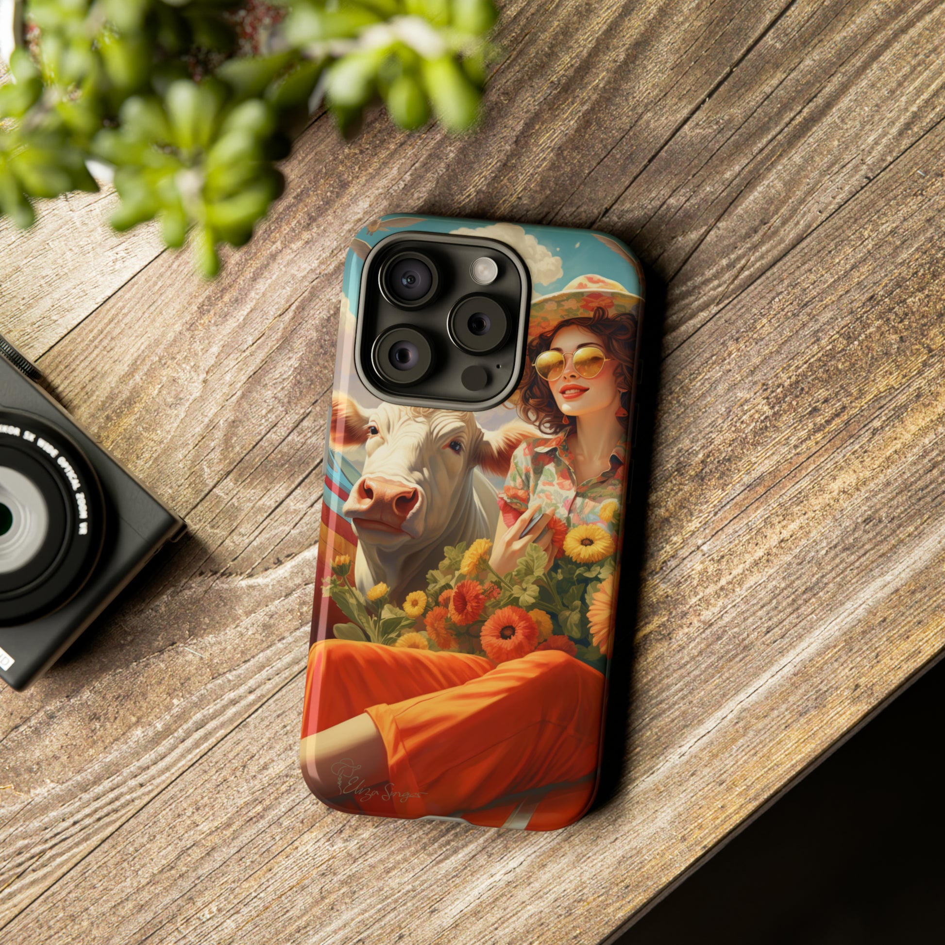 Timeless Retro Charm: Step back in time with our Tough Western Cell Phone Case. Featuring a vintage and bright design, a woman in a hat with daisies is accompanied by a cow looking over her shoulder. Experience the perfect blend of retro aesthetics and durability. Elevate your style with a touch of nostalgia. #ElizaSinger #PhoneCase #RetroStyle 
