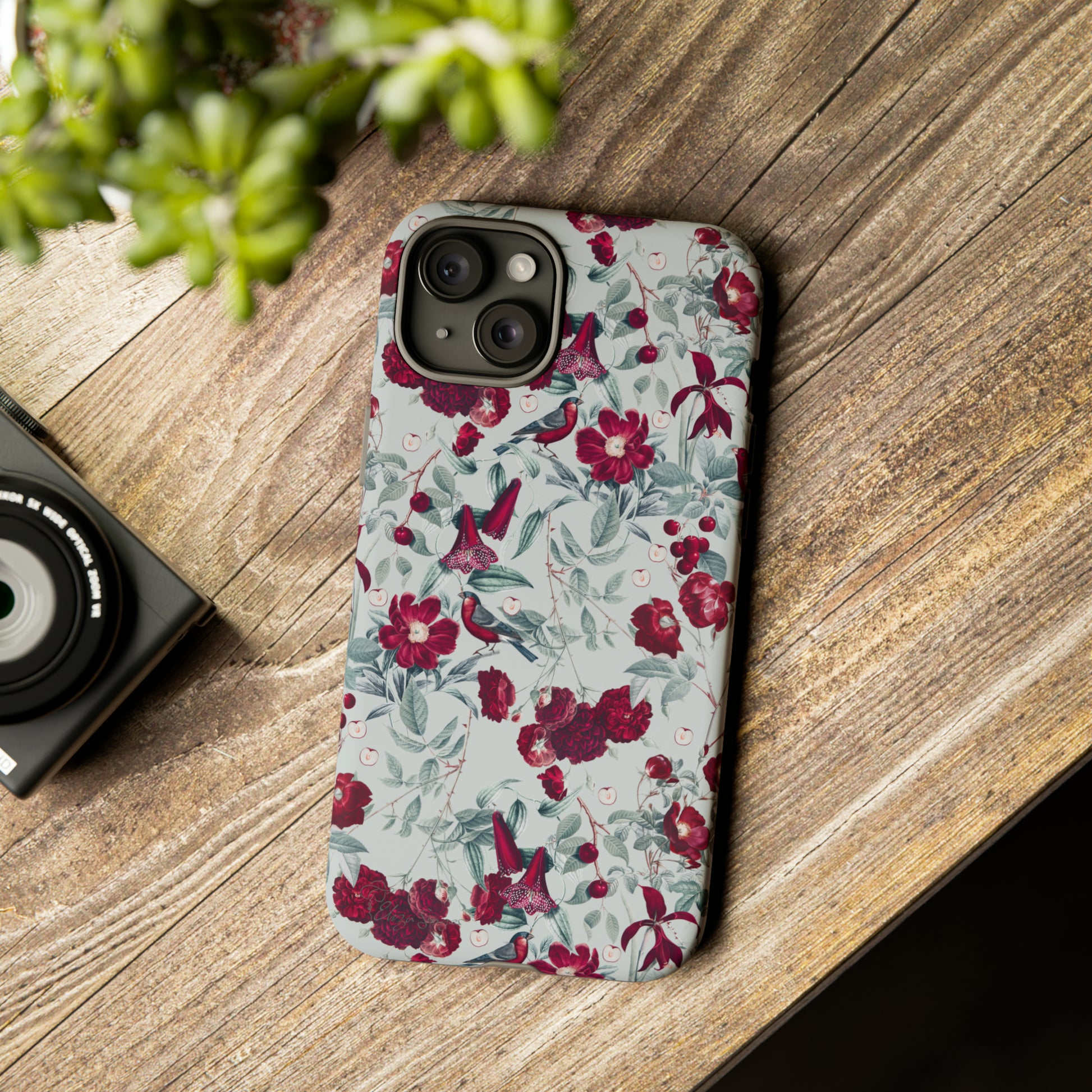 Cherry Blossom Serenade: Cherish nature's beauty with 'Cherry Blossom Serenade.' This iPhone case features flowers and burgundy birds on a blue background, creating a captivating floral wildlife bird and flower design. Elevate your device with this enchanting and stylish protective cover. #ElizaSinger #PhoneCase #FloralDesign