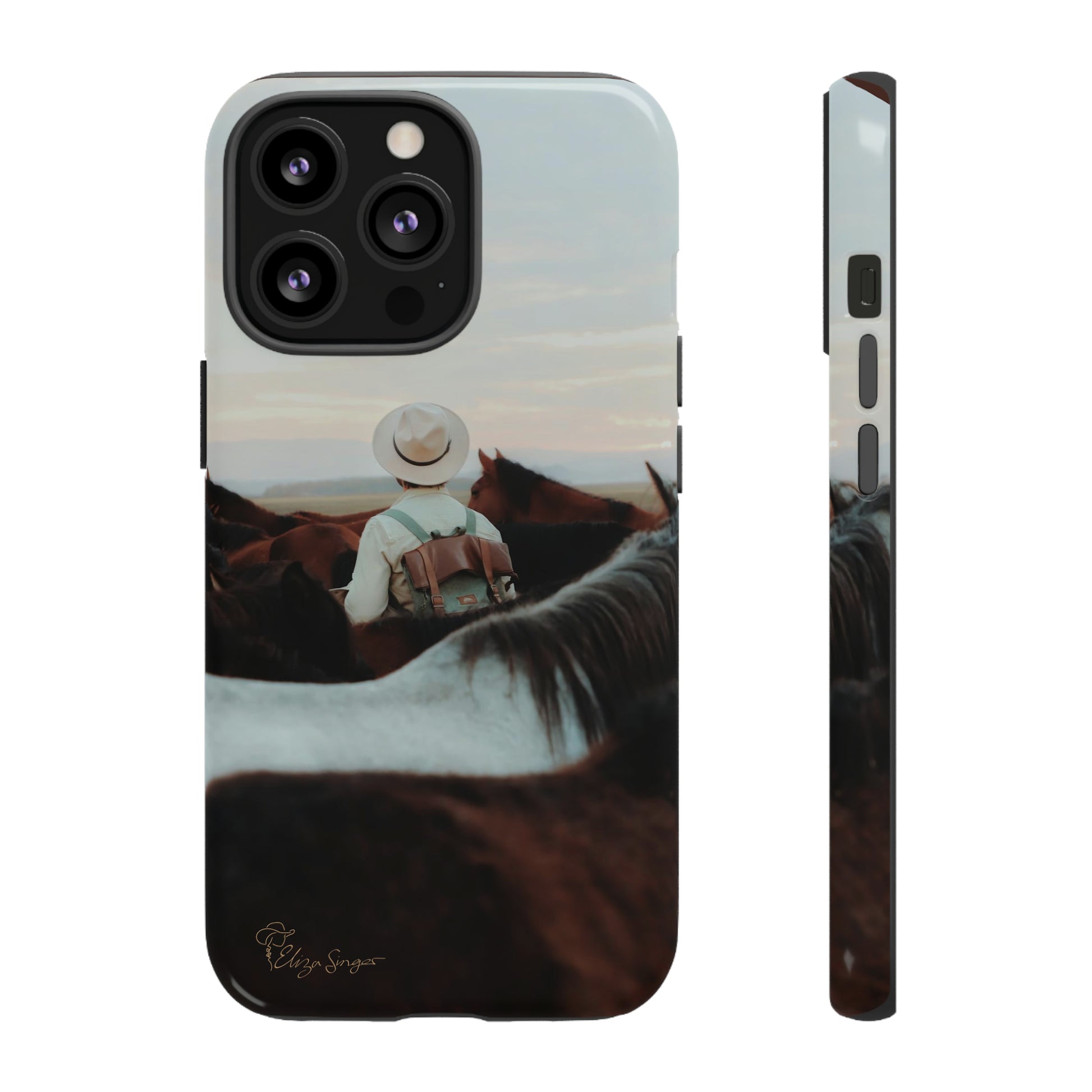 Ride into the Wild: Horse Art Western Photo Yellowstone Design iPhone Tough Protective Cover. Featuring a Cowboy amidst Mountains and Buckskin hues. Compatible with iPhone 15, 14, 13, XS, XR Pro/Max/Mini/P/Plus. Embrace the Spirit of the West with Style and Durability. #ElizaSinger #PhoneCase #WesternDesign