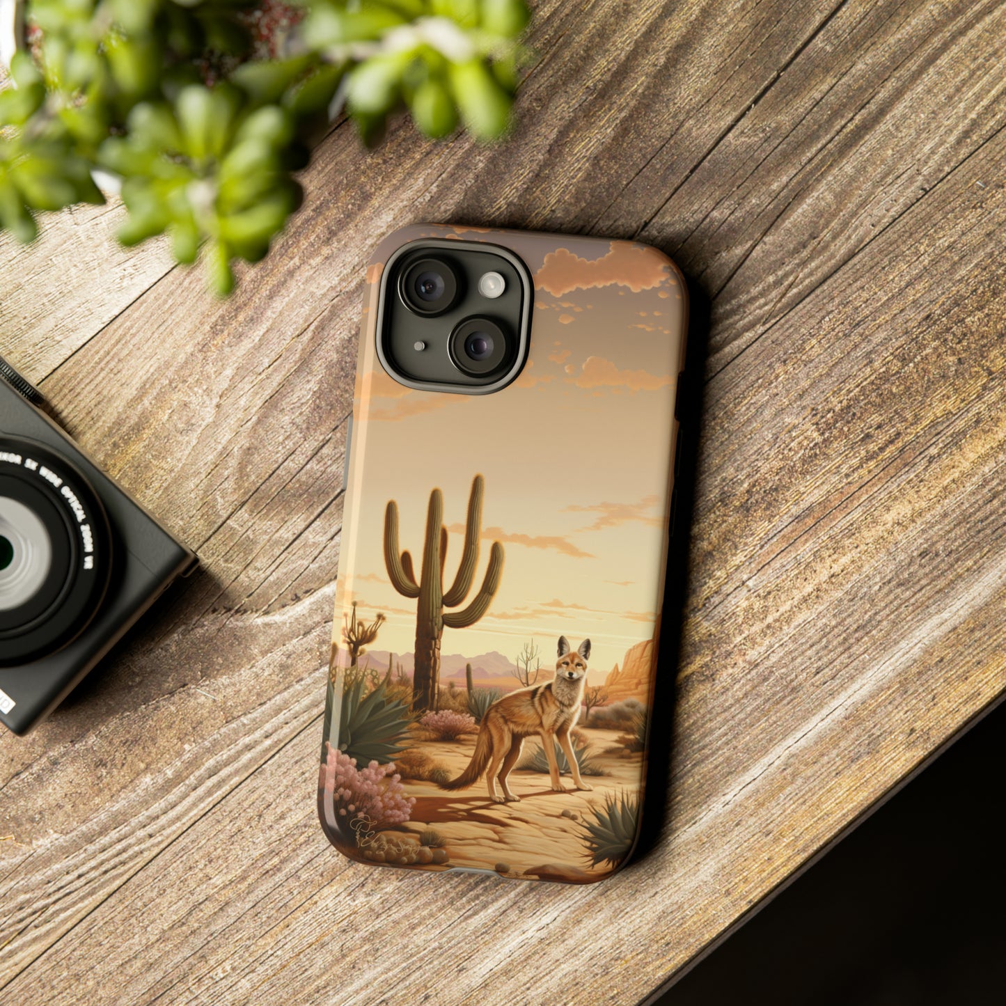 Unveiling our Western Tough Cell Phone Case: Dusk Jackal Oasis Edition! Witness the beauty of dusk with a jackal in a desert landscape next to a cactus. This design offers both rugged protection and a touch of twilight elegance.