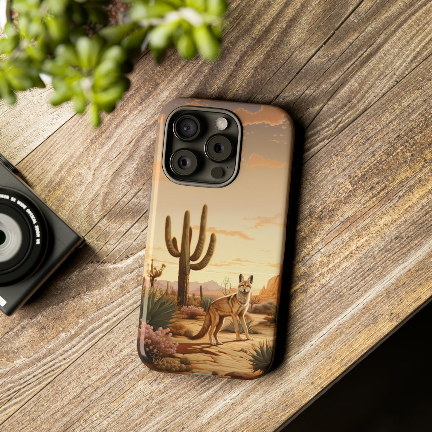 Unveiling our Western Tough Cell Phone Case: Dusk Jackal Oasis Edition! Witness the beauty of dusk with a jackal in a desert landscape next to a cactus. This design offers both rugged protection and a touch of twilight elegance.