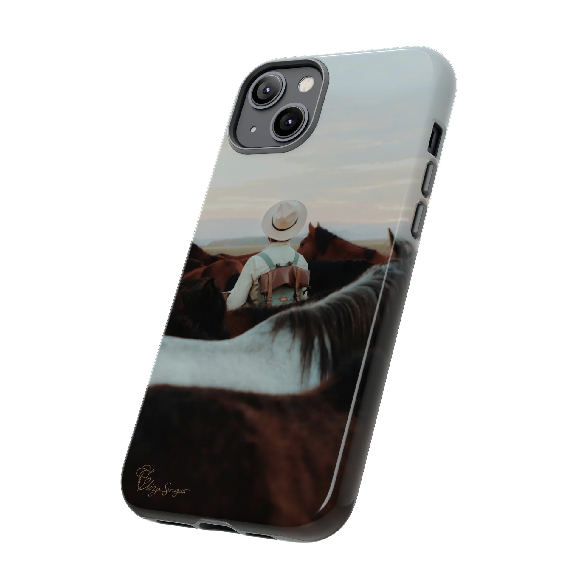 Ride into the Wild: Horse Art Western Photo Yellowstone Design iPhone Tough Protective Cover. Featuring a Cowboy amidst Mountains and Buckskin hues. Compatible with iPhone 15, 14, 13, XS, XR Pro/Max/Mini/P/Plus. Embrace the Spirit of the West with Style and Durability. #ElizaSinger #PhoneCase #WesternDesign