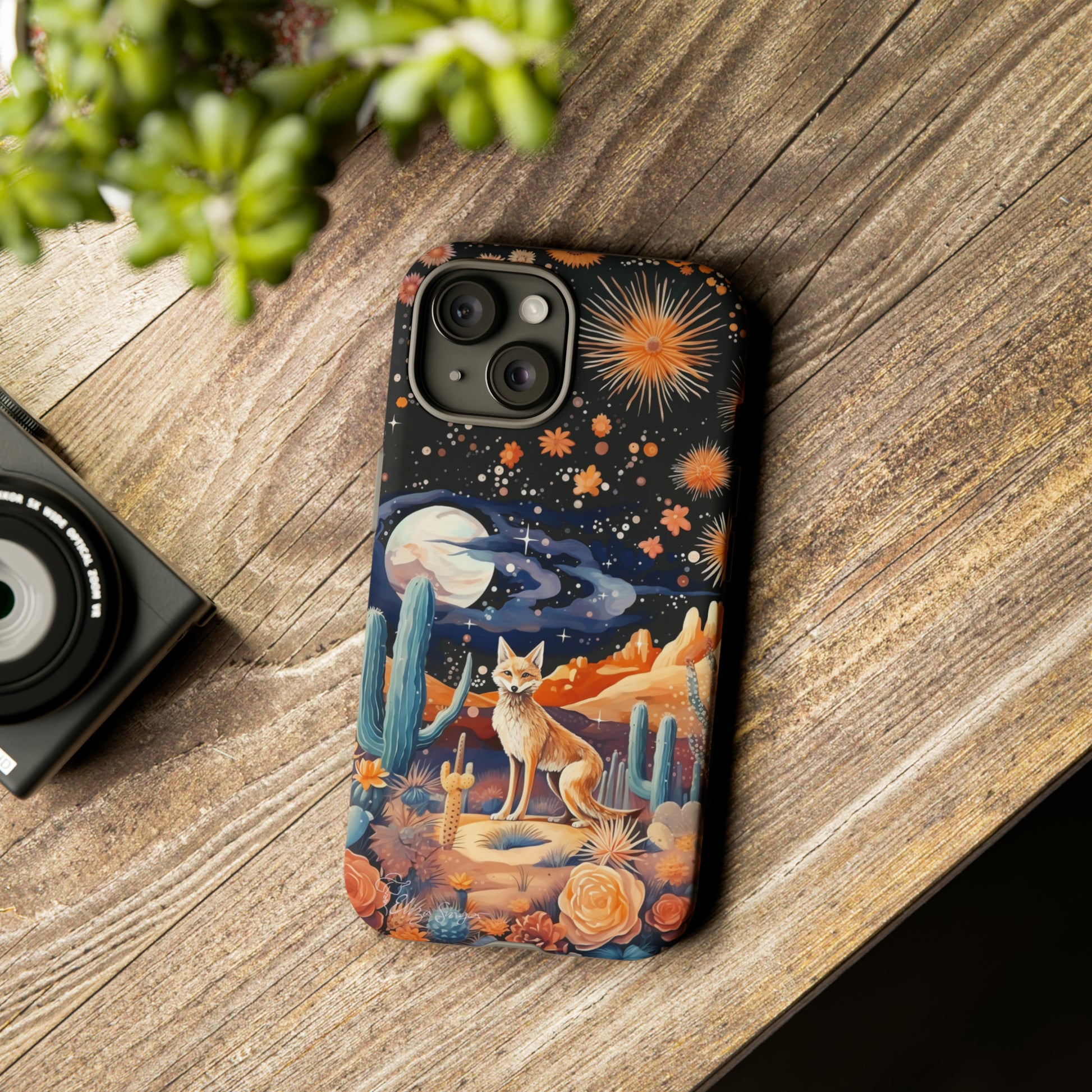 Introducing our Tough Western Cell Phone Case: Midnight Mirage Jackal Edition! Dive into the mysterious desert night with a striking depiction of a jackal, cacti, and a starry sky. This design offers the ideal combination of durability and desert charm.
