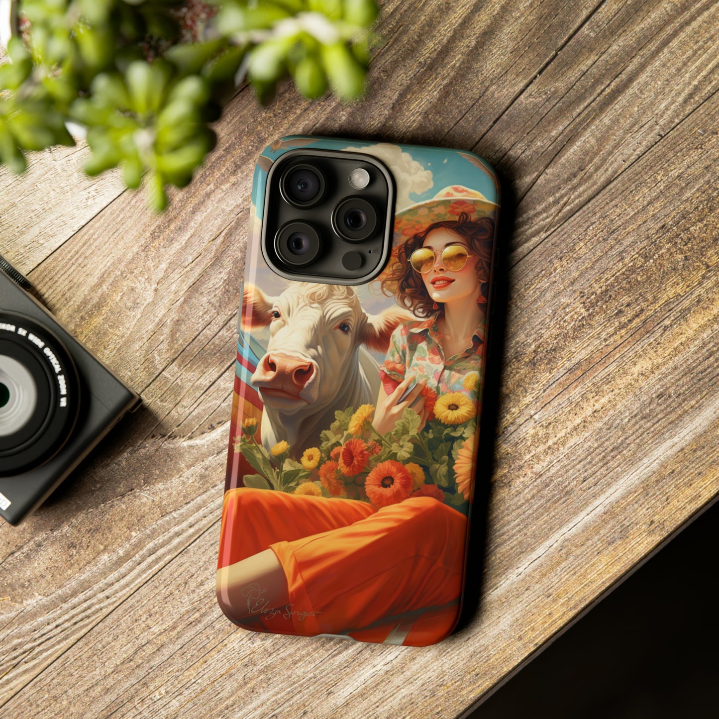 Timeless Retro Charm: Step back in time with our Tough Western Cell Phone Case. Featuring a vintage and bright design, a woman in a hat with daisies is accompanied by a cow looking over her shoulder. Experience the perfect blend of retro aesthetics and durability. Elevate your style with a touch of nostalgia. #ElizaSinger #PhoneCase #RetroStyle 