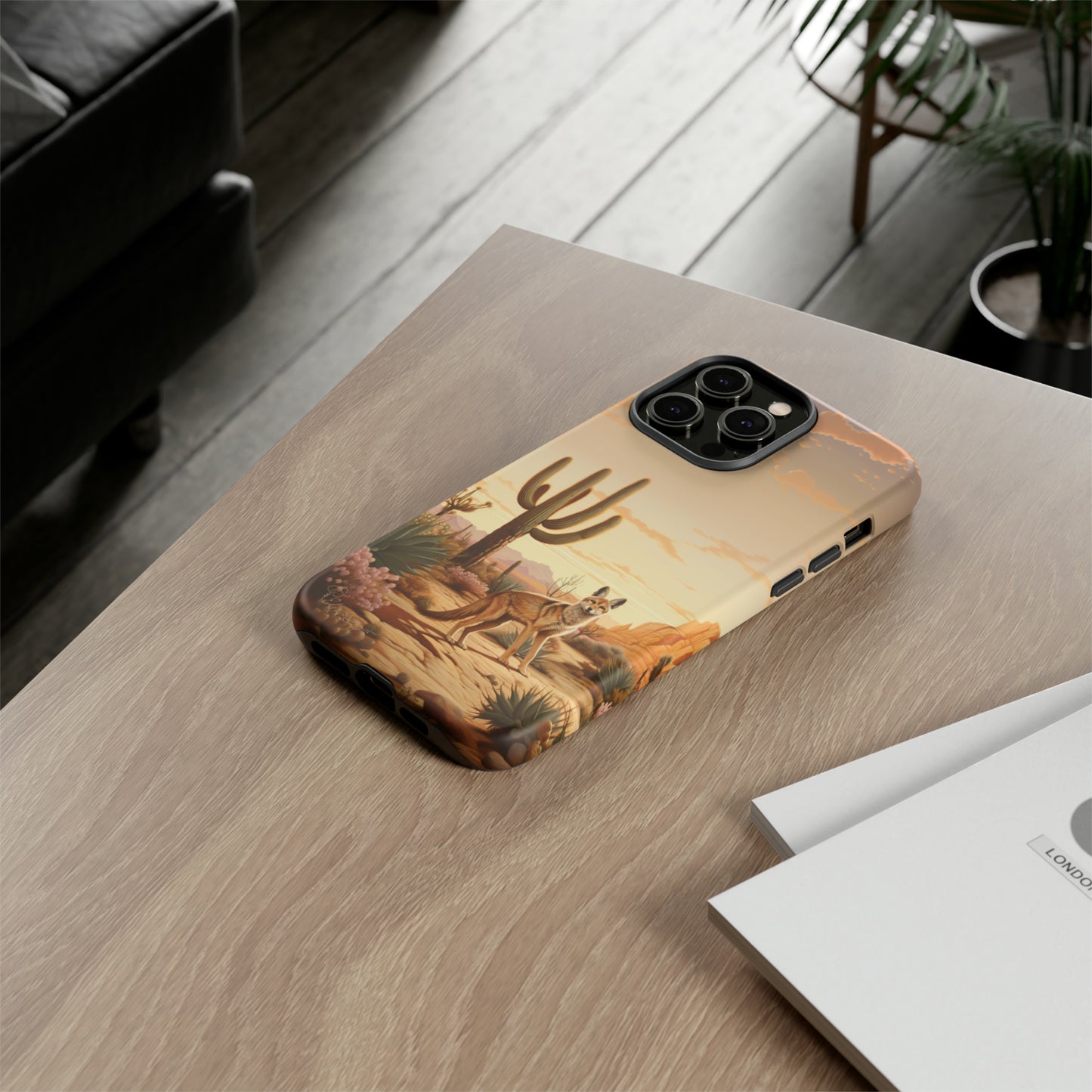 Unveiling our Western Tough Cell Phone Case: Dusk Jackal Oasis Edition! Witness the beauty of dusk with a jackal in a desert landscape next to a cactus. This design offers both rugged protection and a touch of twilight elegance.