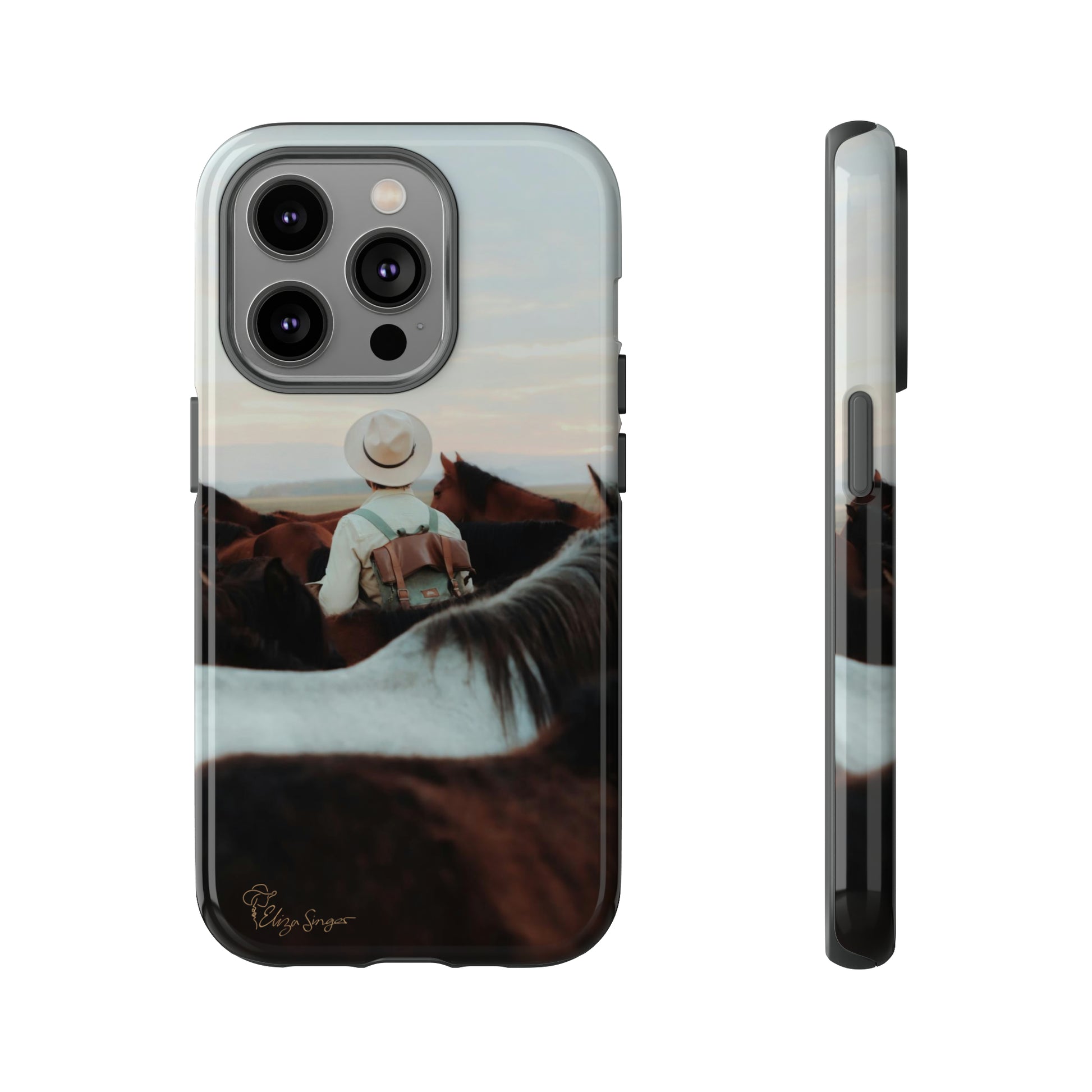 Ride into the Wild: Horse Art Western Photo Yellowstone Design iPhone Tough Protective Cover. Featuring a Cowboy amidst Mountains and Buckskin hues. Compatible with iPhone 15, 14, 13, XS, XR Pro/Max/Mini/P/Plus. Embrace the Spirit of the West with Style and Durability. #ElizaSinger #PhoneCase #WesternDesign