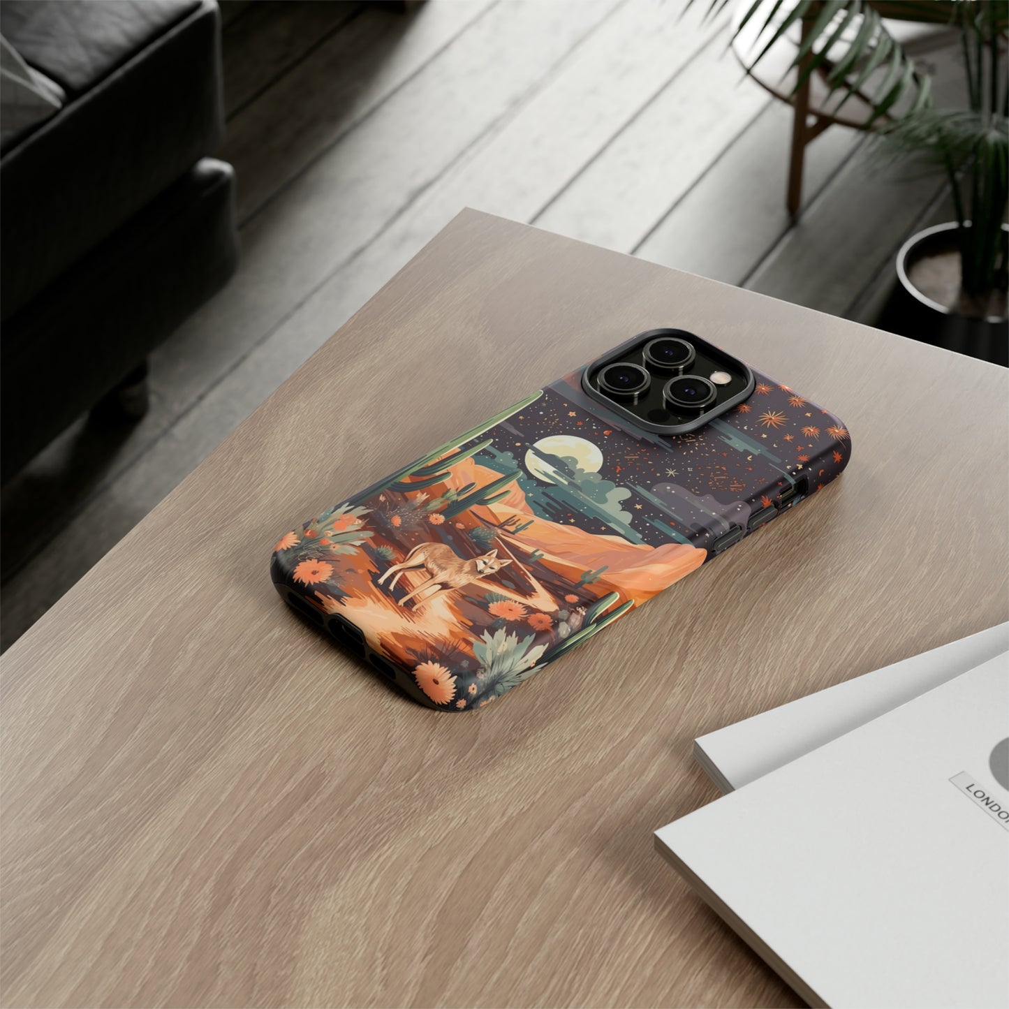 Introducing our Tough Western Cell Phone Case: Twilight Desert Jackal Remix Edition! A variation of our popular design, this edition features a jackal in a desert landscape with a starry night sky and cacti. Get ready for a unique twist on classic rugged protection.