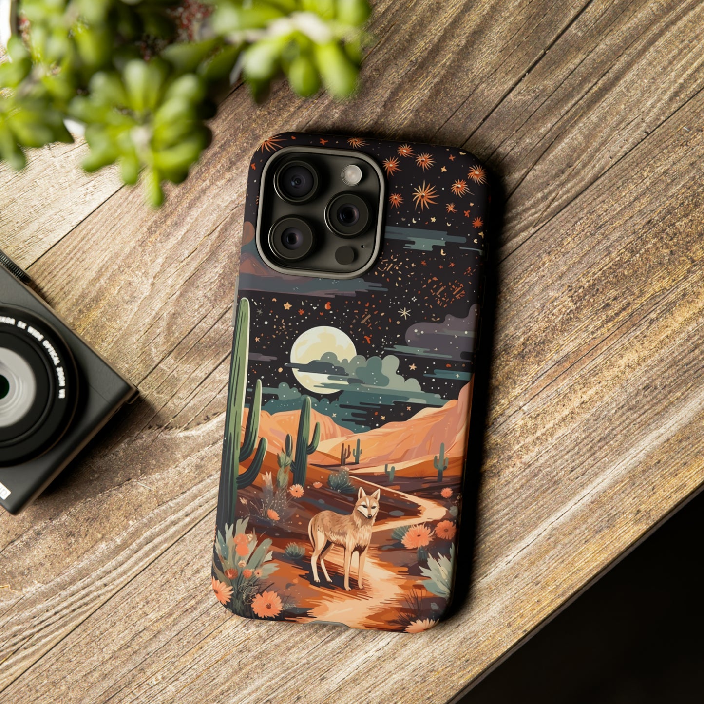 Introducing our Tough Western Cell Phone Case: Twilight Desert Jackal Remix Edition! A variation of our popular design, this edition features a jackal in a desert landscape with a starry night sky and cacti. Get ready for a unique twist on classic rugged protection.