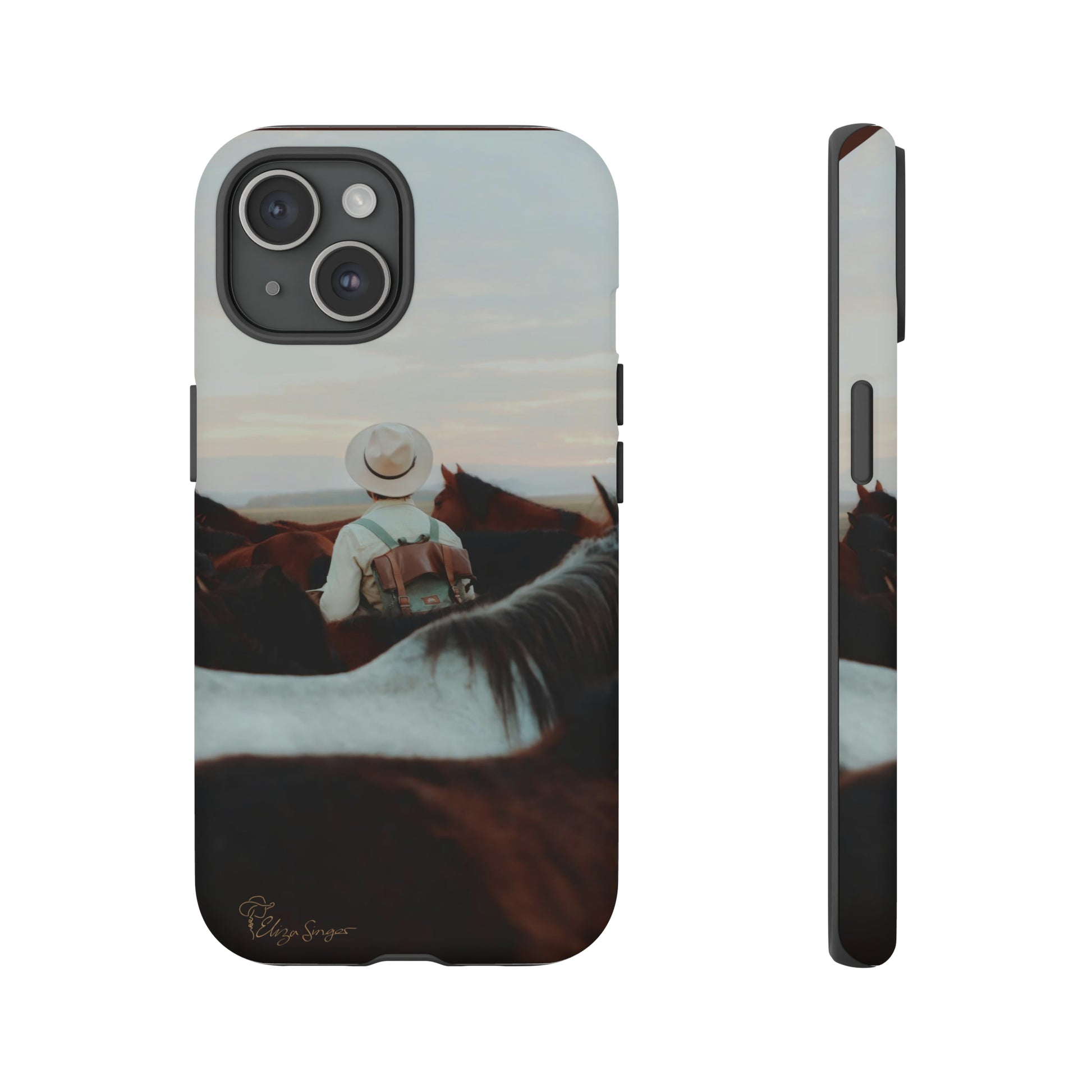 Ride into the Wild: Horse Art Western Photo Yellowstone Design iPhone Tough Protective Cover. Featuring a Cowboy amidst Mountains and Buckskin hues. Compatible with iPhone 15, 14, 13, XS, XR Pro/Max/Mini/P/Plus. Embrace the Spirit of the West with Style and Durability. #ElizaSinger #PhoneCase #WesternDesign
